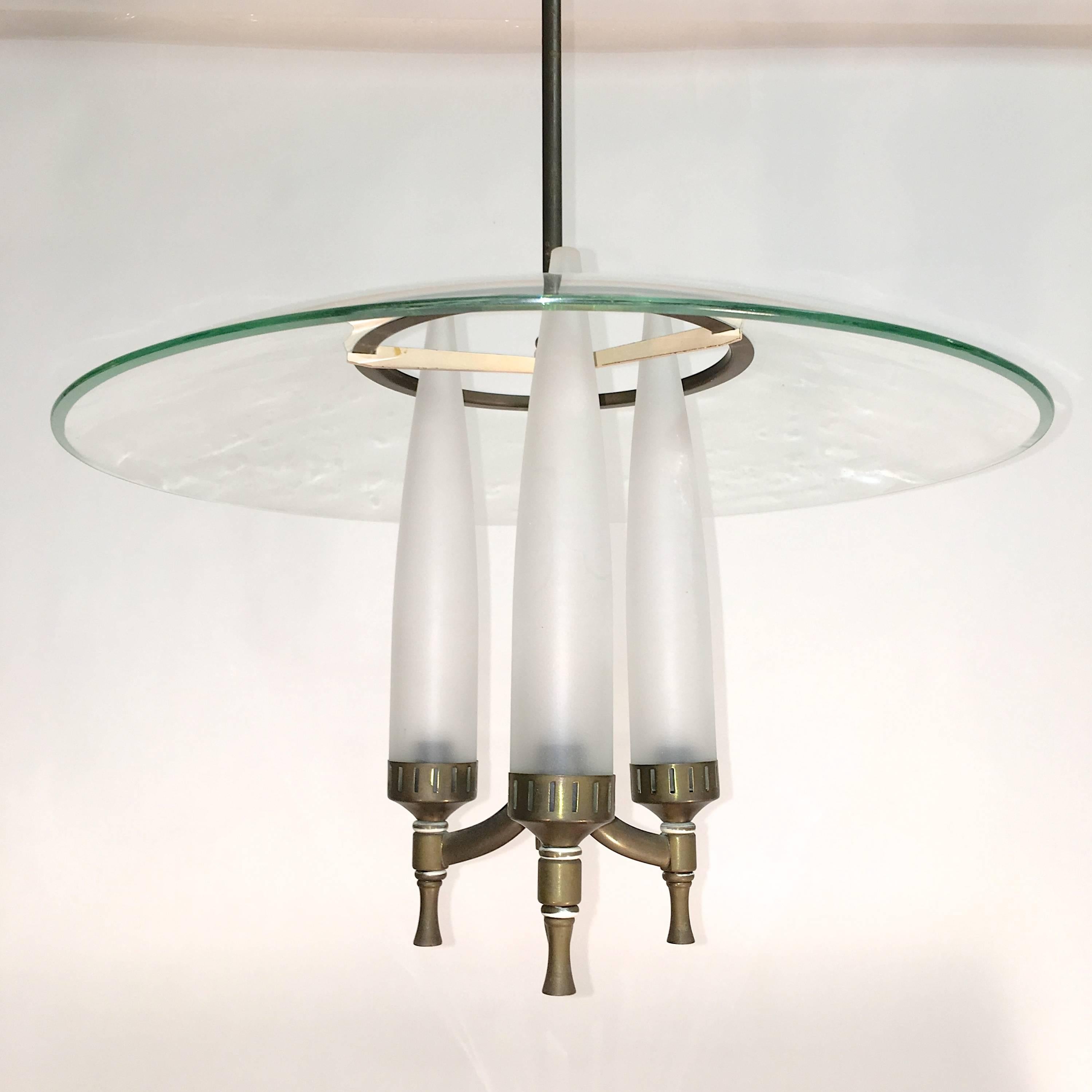1940s Italian chandelier in the style of Fontana Arte. Tripod form candelabra pendant fixture with ivory enameled armature suspended from a slim stem including the original conical ceiling canopy. Three satin glass candle form tubular shades fit