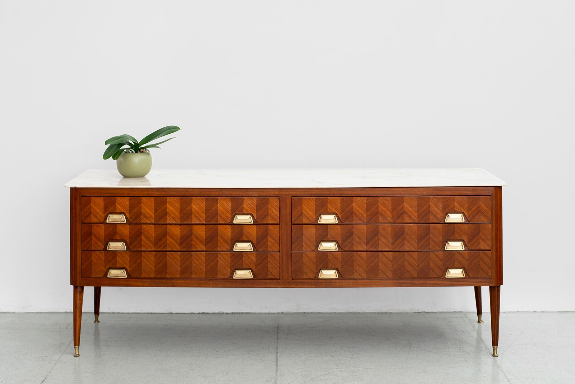 Gorgeous Italian mahogany sideboard with marquetry inlay wood in herringbone pattern. 
Marble top with beautiful grain.
Tapered legs with brass hardware and brass tipped legs.