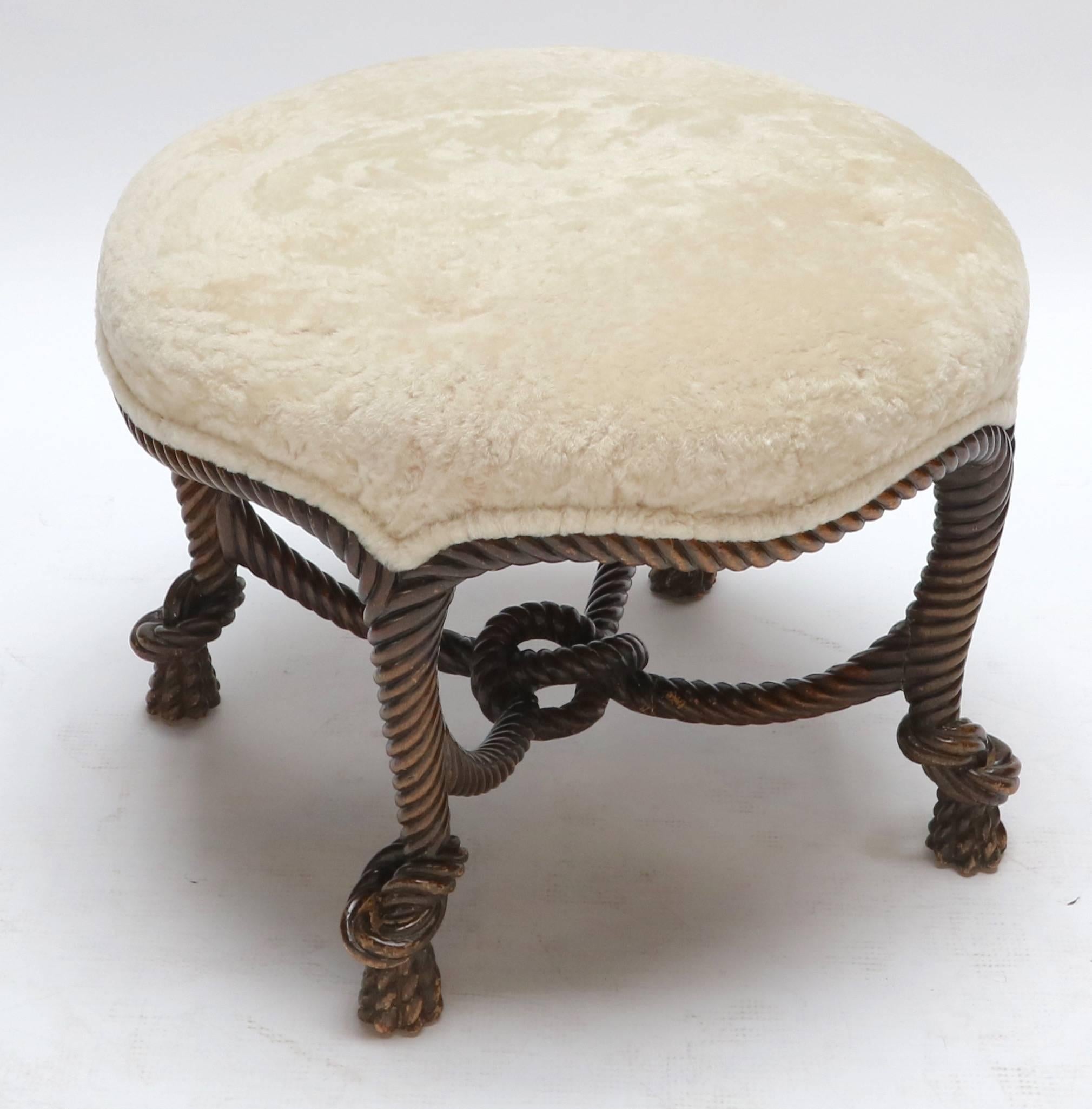 1940s, Italian carved wood ottoman upholstered in sheepskin with rope shaped legs and knot in the middle.