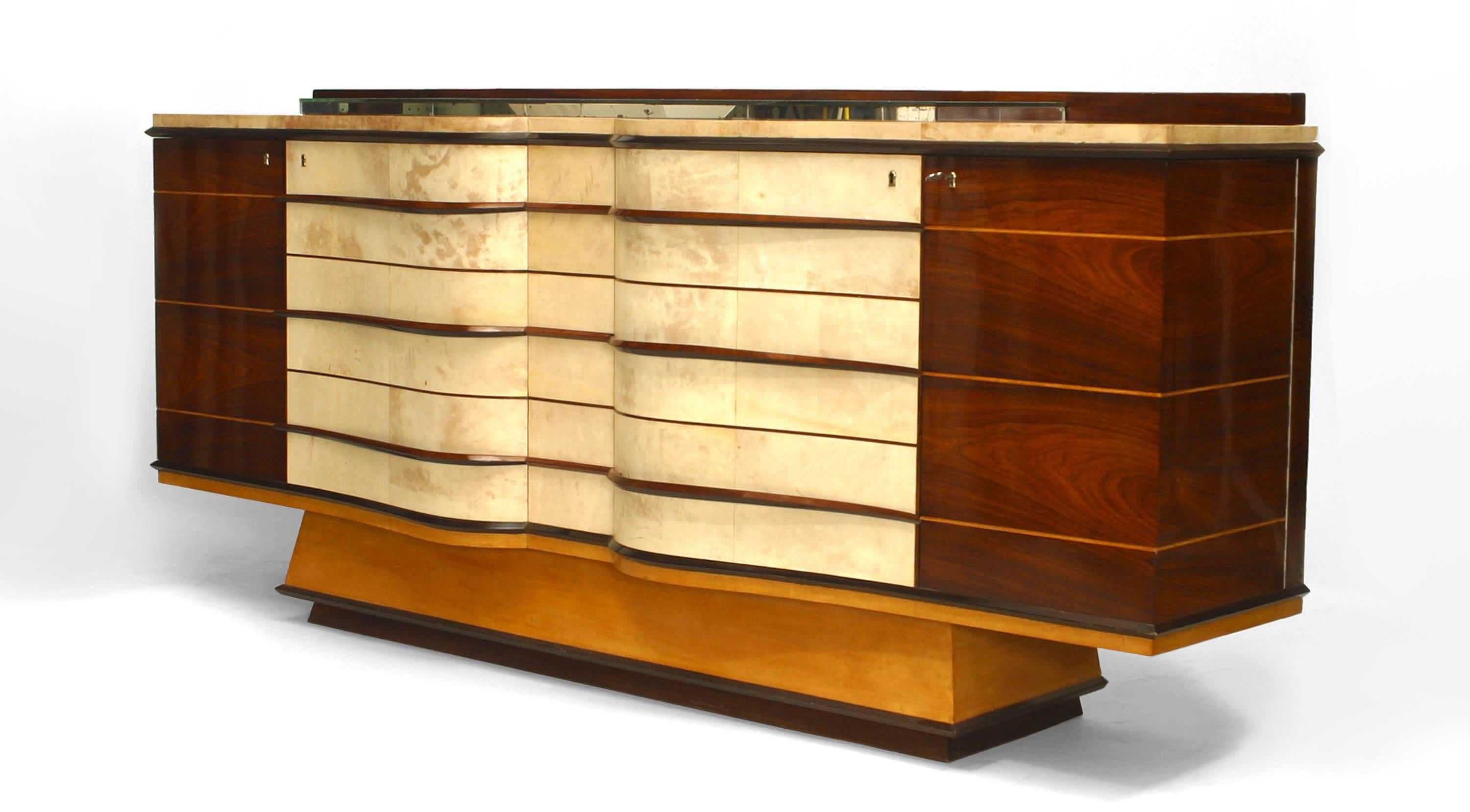 Italian Mid-Century (1940s) rosewood and parchment 4 door sideboard elevated on a maple base with a raised mirrored center top (signed: DAGHIA, BOLOGNA)
