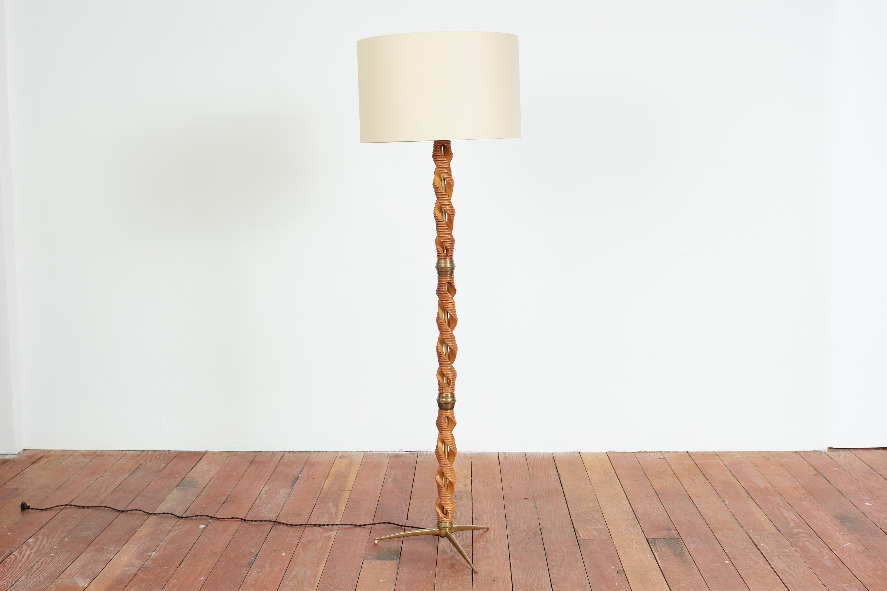 Stunning carved wood and brass floor lamp with cast brass tripod base and fittings. 
Wood is hand carved and truly unique. 
Newly rewired and silk shade
Italy, 1940s 
