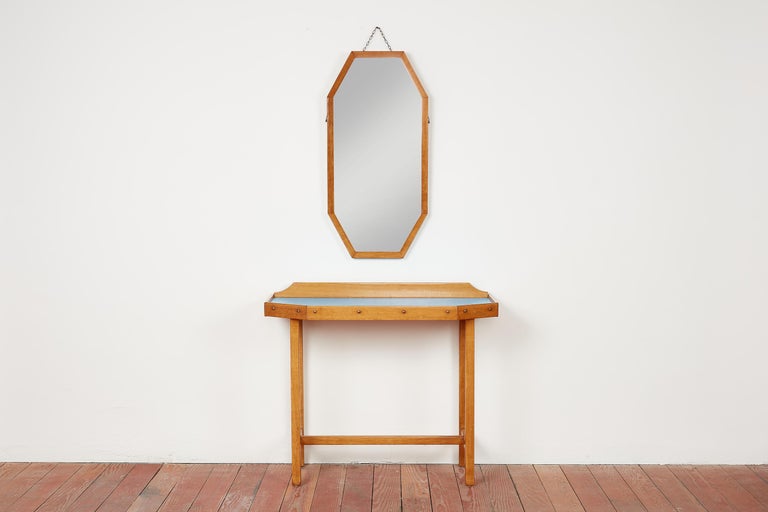 1940's Italian vanity console with matching mirror.
Lacquered maple wood with blue laminate top.
Great angular shape with matching mirror.
Brass hardware.
Console does not have drawers.

Mirror - 18