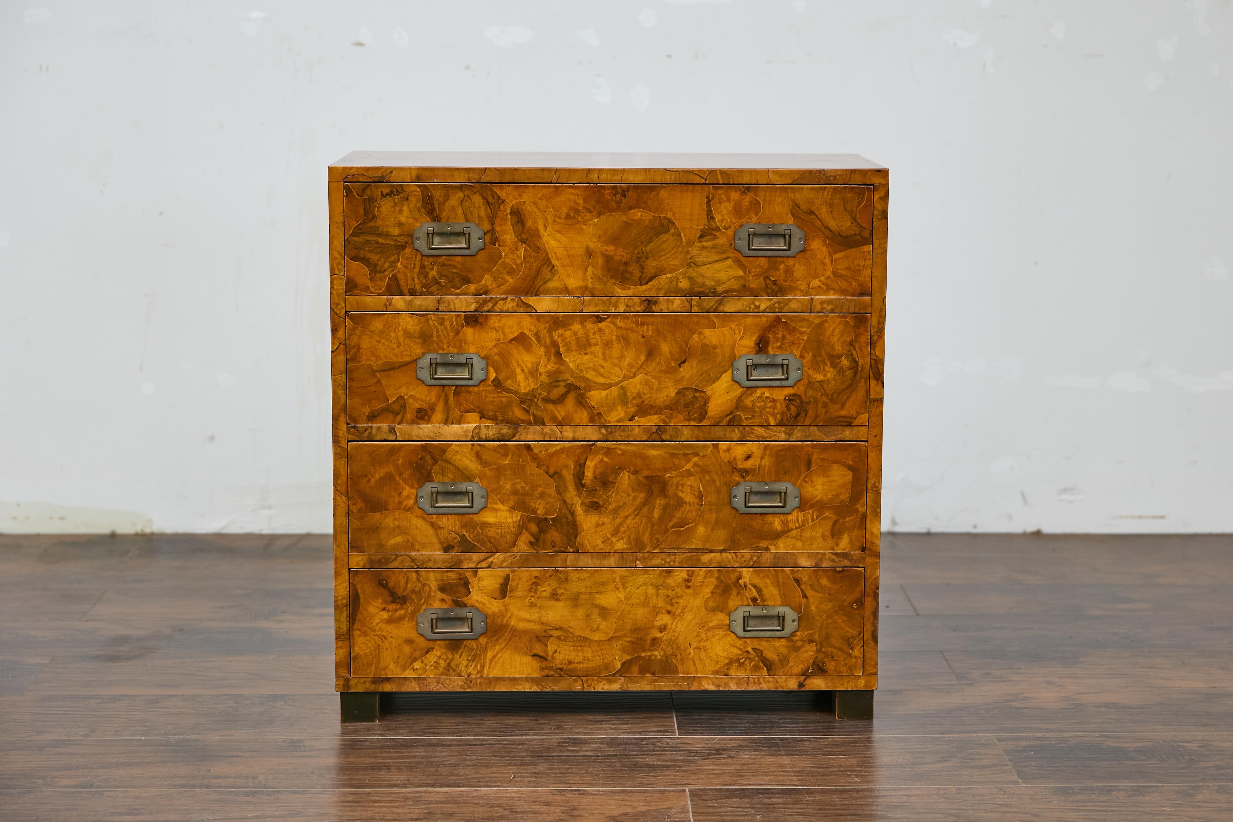 An Italian walnut veneer commode from circa 1940 with four drawers and linear brass inset hardware. This Italian walnut commode from circa 1940 captures the essence of refined elegance with its beautifully grained surface and clean, minimalist