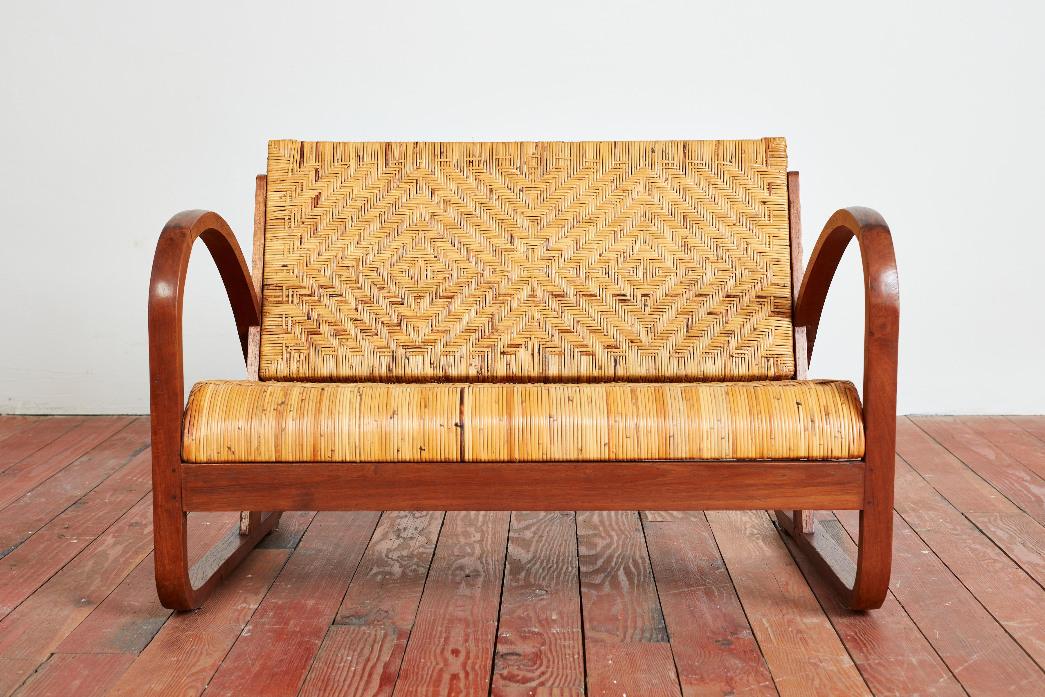 1940s Italian settee with patterned wicker seat and back in the style of Paolo Buffa. 
Angular wood frame in loop shape with wonderful original patina.
Matching pair of chairs available - sold separately.