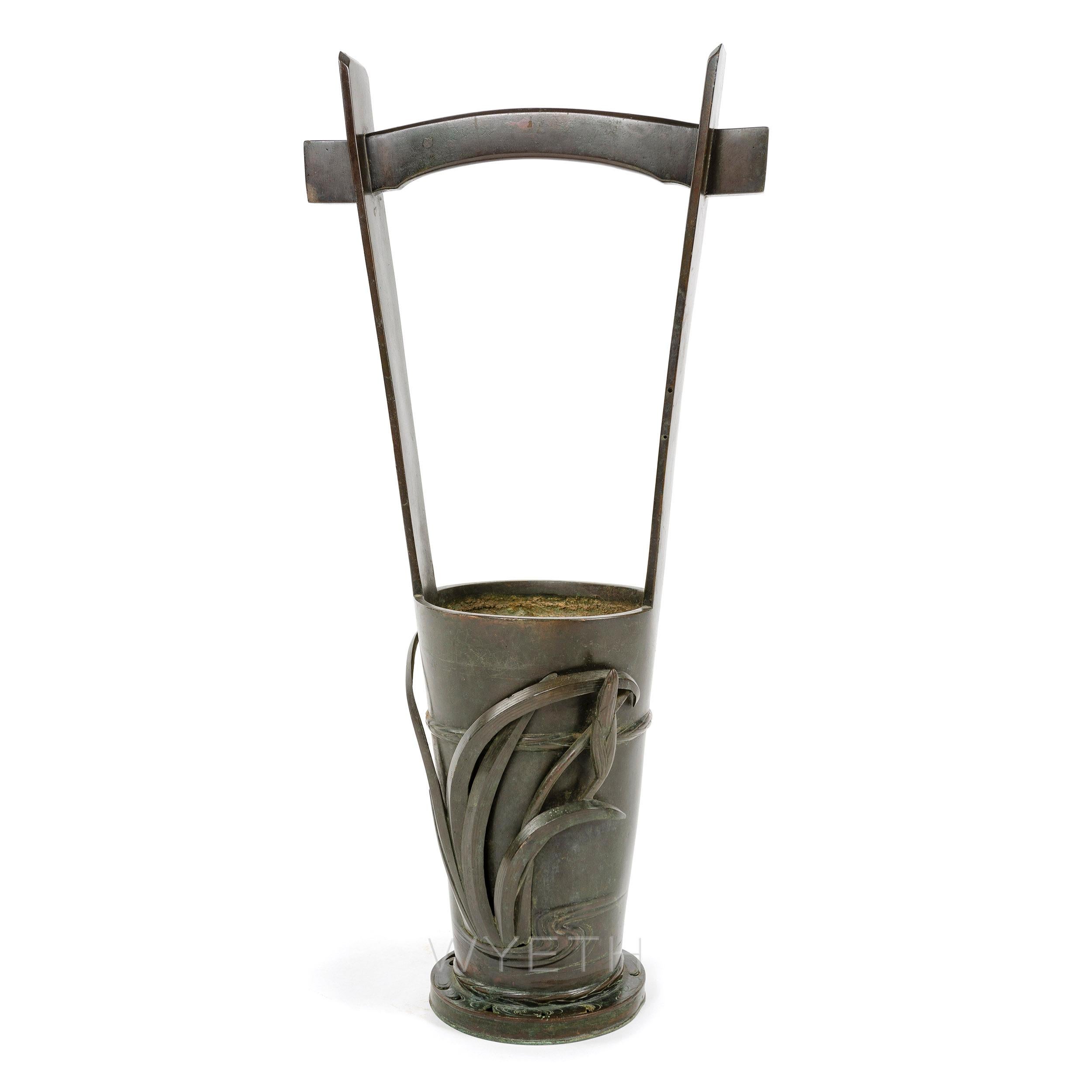 A finely crafted darkened bronze umbrella stand with an expressive leaf motif.