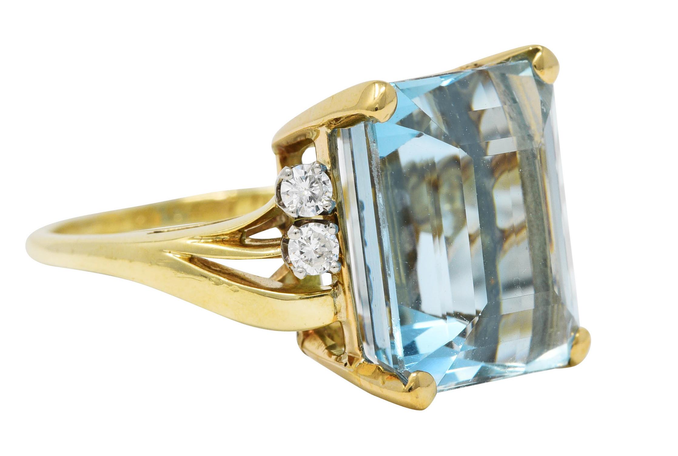 Featuring an emerald cut aquamarine weighing approximately 10.00 carats. Eye clean with medium greenish blue color. Basket set and flanked by torqued tri-split shoulders. Accented by round brilliant cut diamonds weighing in total approximately 0.15