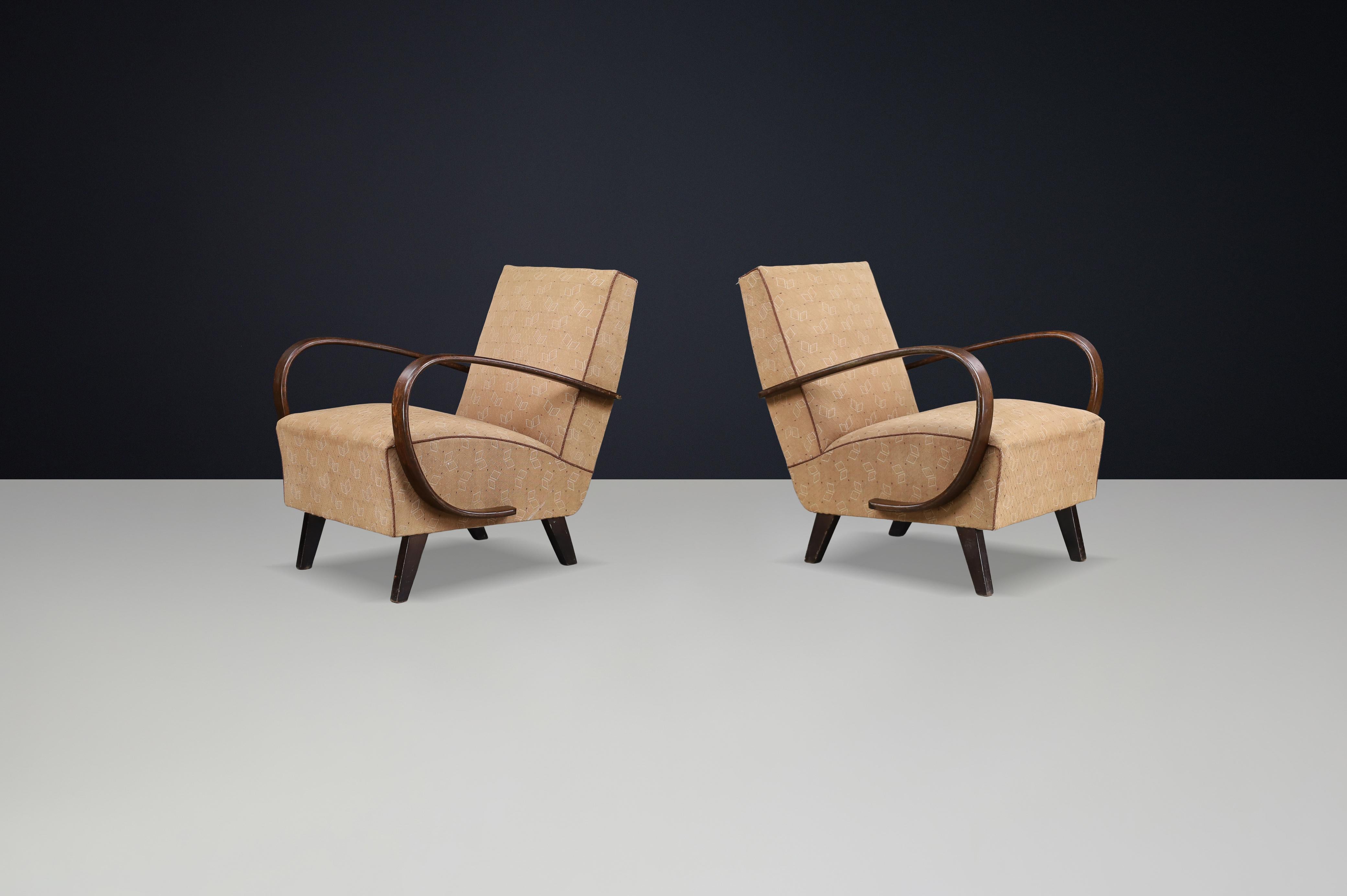 Pair of 1940s Jindřich Halabala H-227 Bentwood Armchairs with Original Upholstery

Offered here is a rare and refined pair of Model H-227 armchairs designed by celebrated Czech modernist Jindřich Halabala in the 1940s. Unlike the more commonly seen