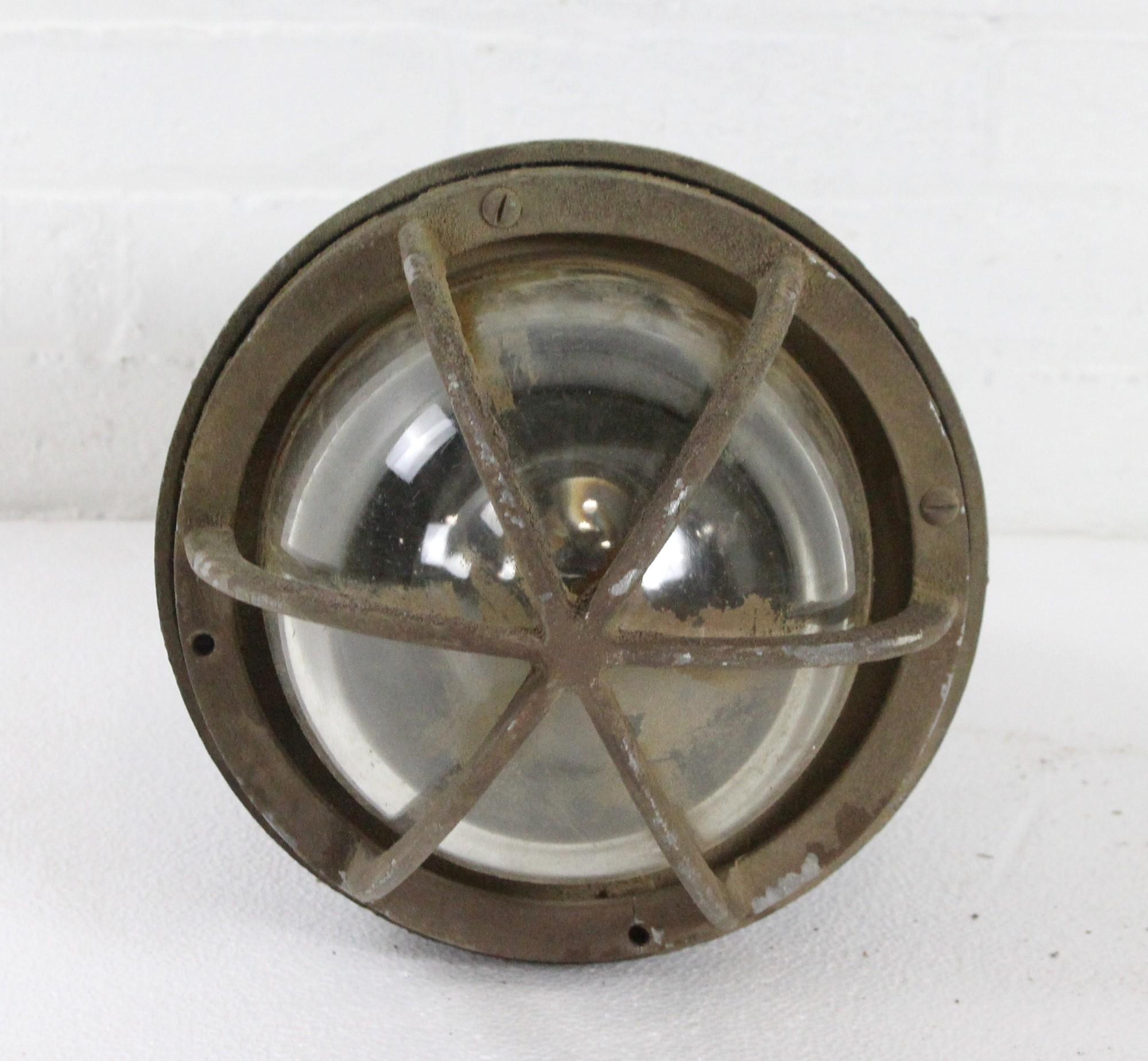 Large scale 1940s explosion proof light retrieved from an industrial factory. Made of cast aluminum with a cage over a spherical glass lens. Made by Killark Electric MFG. Co. This can be seen at our 400 Gilligan St location in Scranton, PA.
