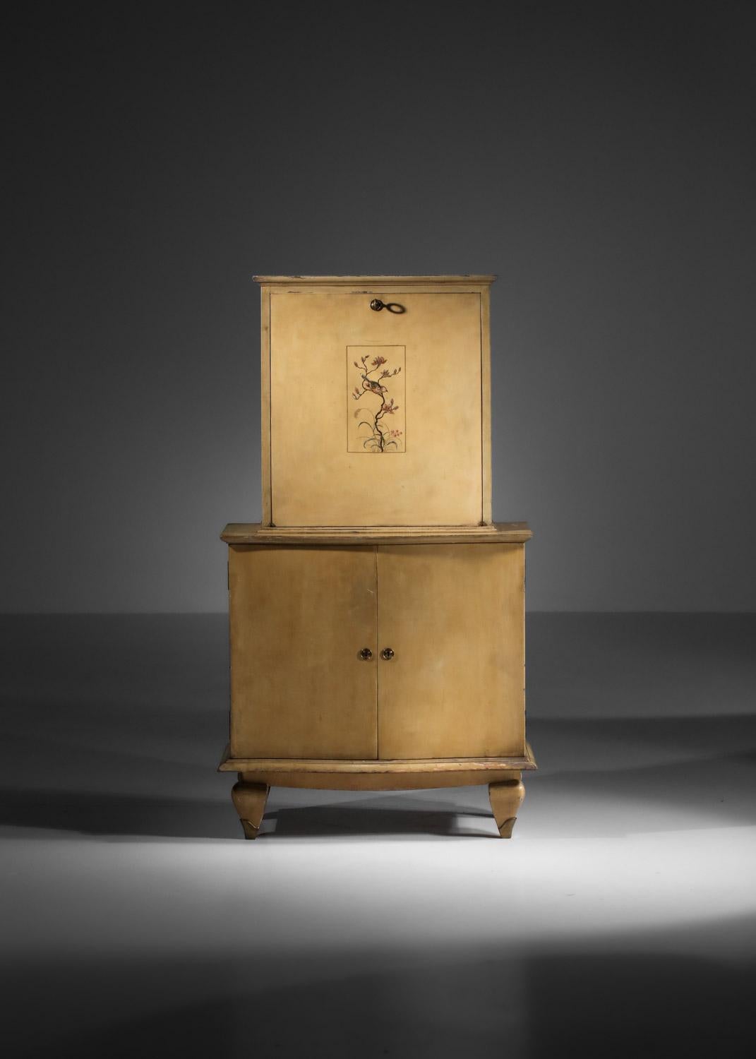 Rare '40s secrétaire attributed to French designer René Drouet. Structure in lacquered solid wood with attractive floral decoration on the top door (original paint, gilding and lacquering). Mahogany veneered interior and solid brass feet. Very high