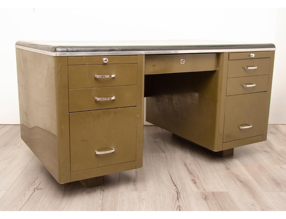 1940s steel tanker desk in its original military olive green with a black rubberised desk top. The desk was originally designed to be fire proof. There are three drawers on either side with a pull out hanging document drawer at the bottom. A slim