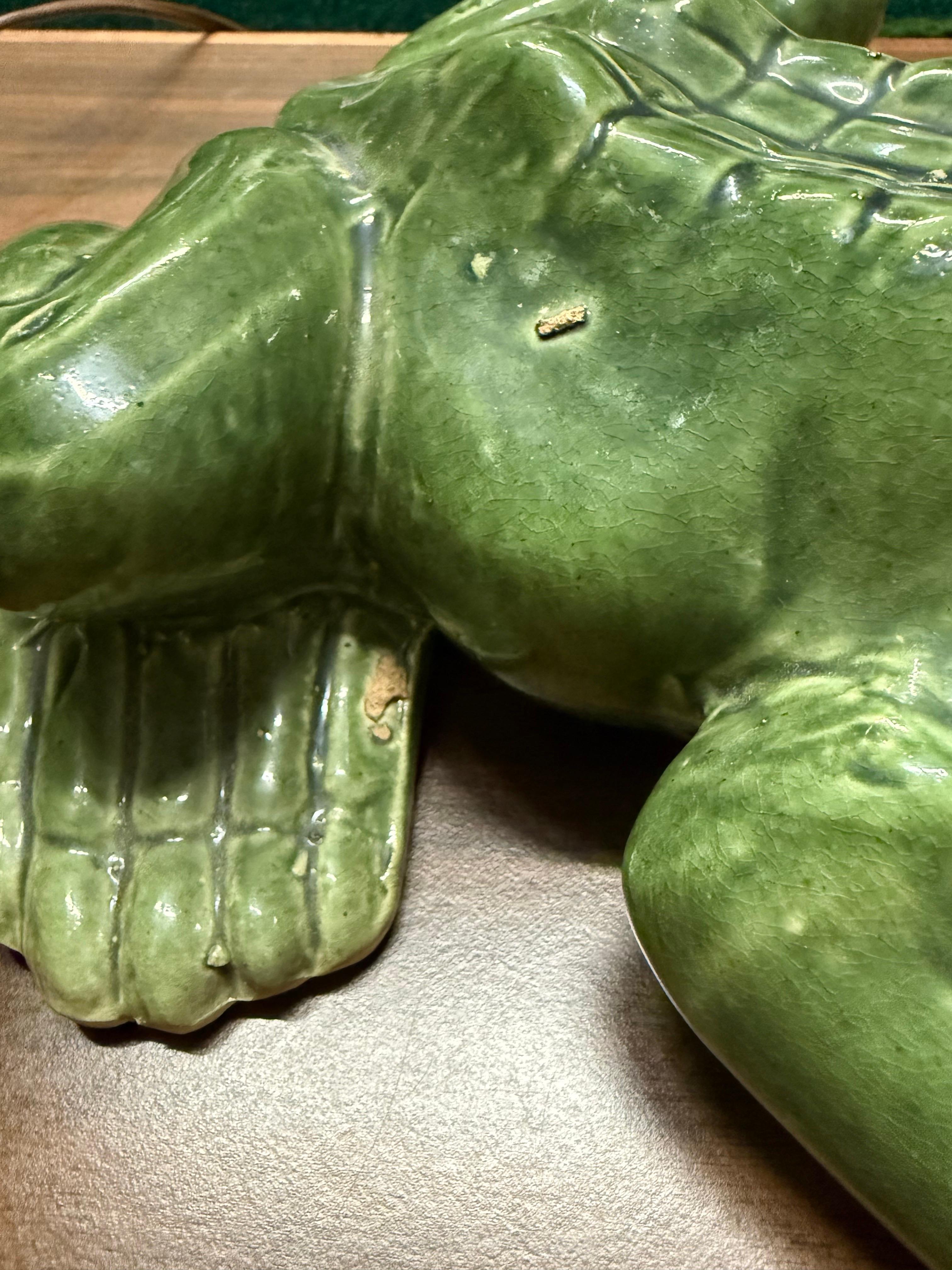 Large Majolica style garden frog.   This cute little bugger was hand crafted and hand painted.   You can see the flaws that were made during the production of this piece.  It is not marked on the bottom, but I believe after lots of research, that it