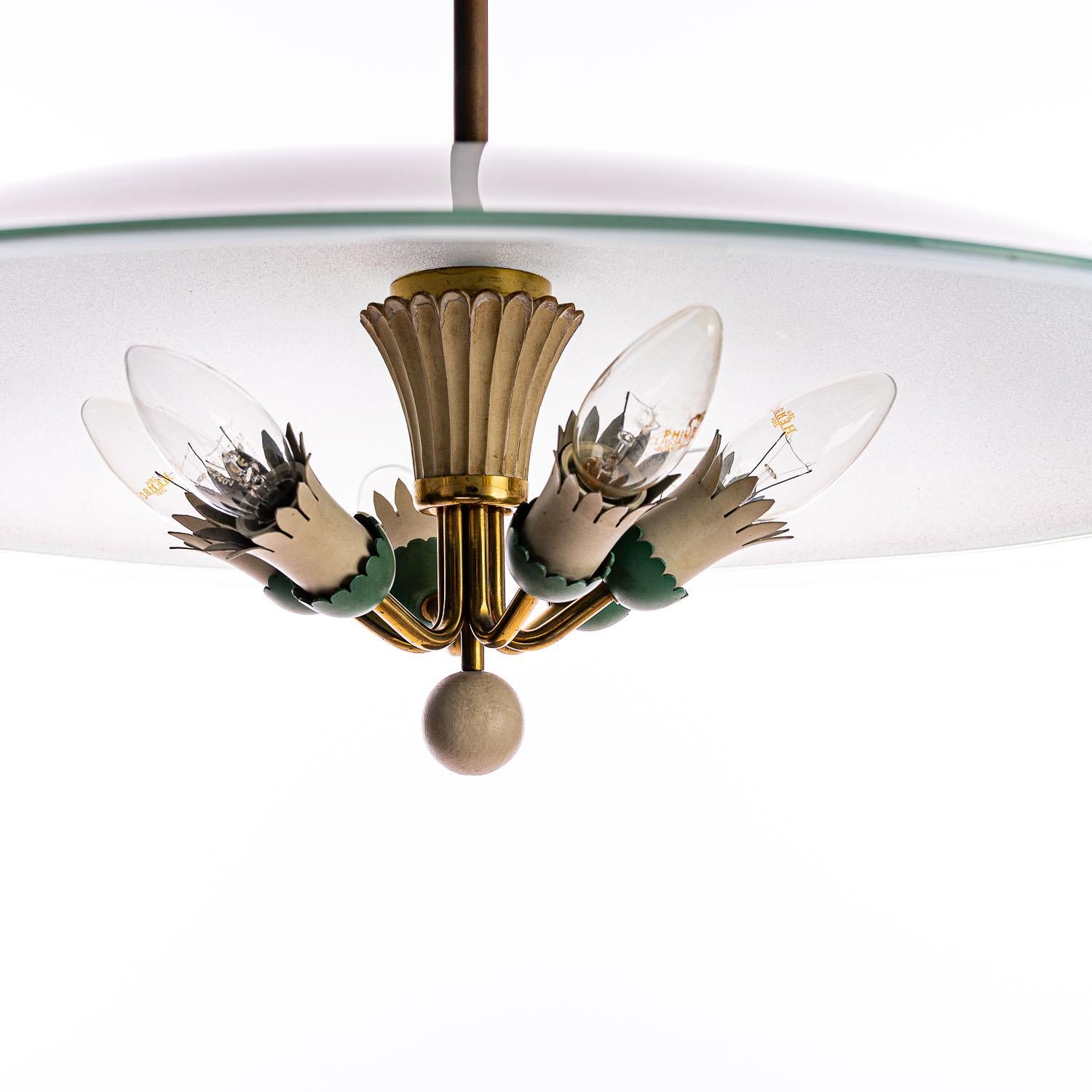 This elegant, surprisingly large pendant light consisting of a brass frame and one unique large glass reflector. In the center 6 electrical E14 polychromed metal sockets and a brass stem.

Please note, we have multiple ‘saucer’- lighting in stock.