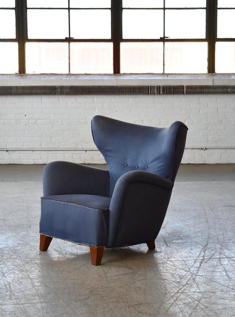 Incredibly comfortable, exuberant designed high back lounge chair in the style of Flemming Lassen's famous 