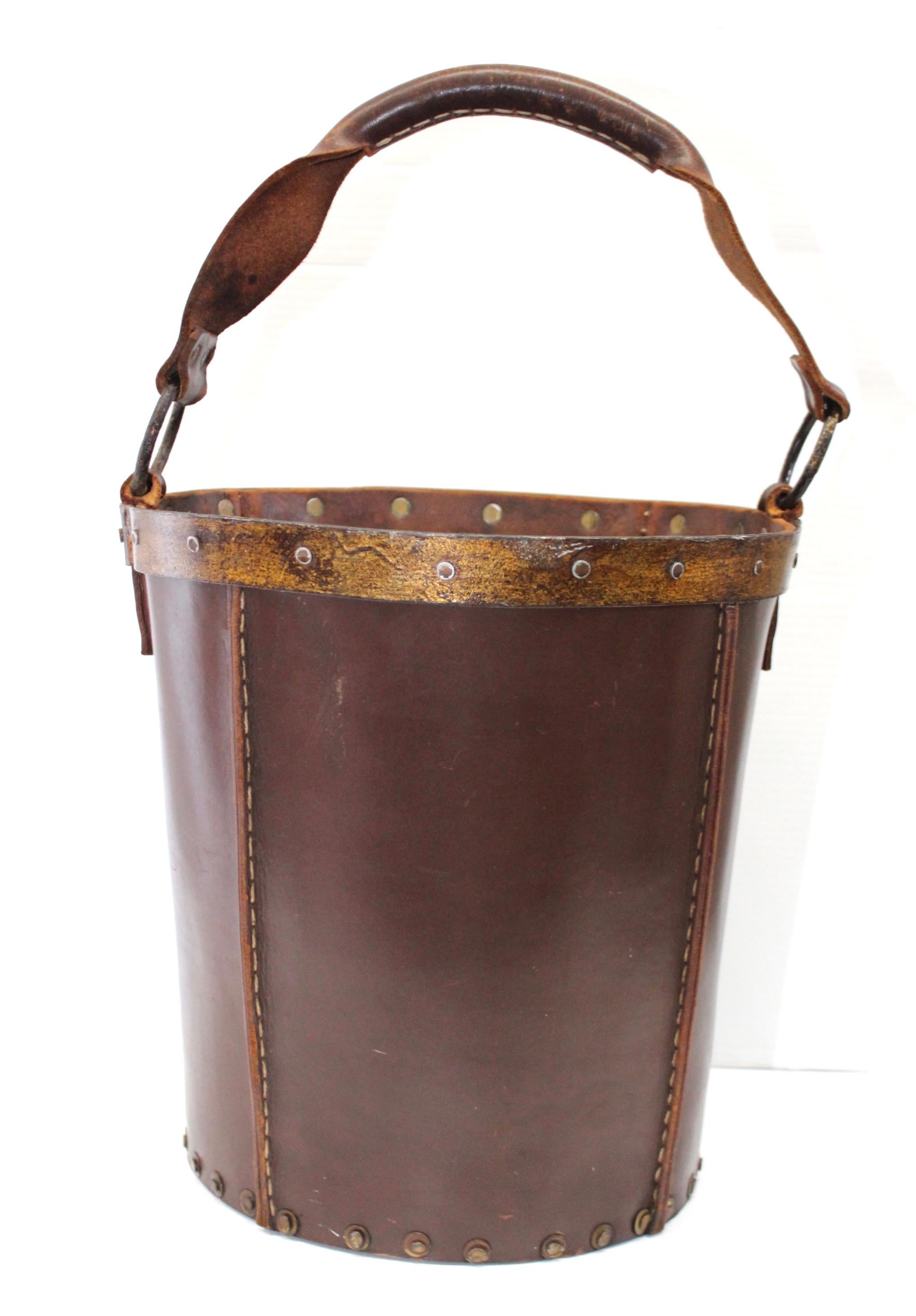 1940s leather, metal and wood wastebasket from Spain, beautiful craftsmanship with stitching detail and nice patina to the leather.

Measures: Height including handle 21”.