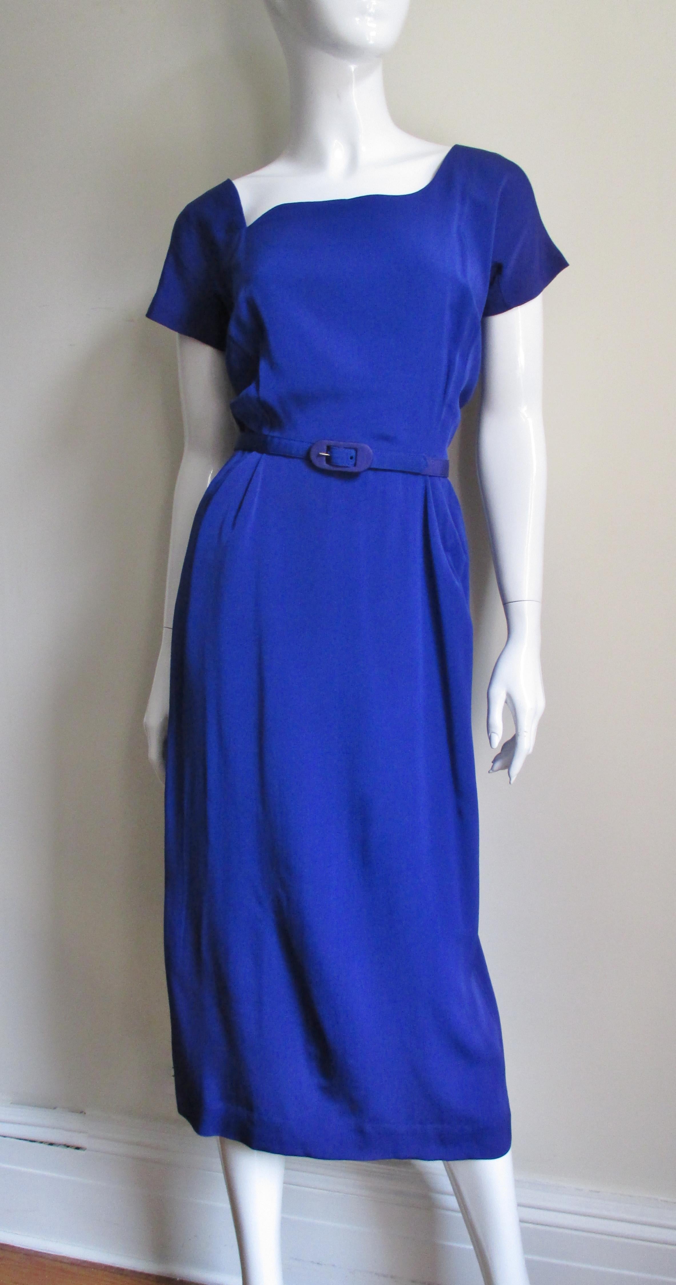 It's becoming more and more rare to come across an unworn dress from this era.  The purple silk grosgrain dress has a fabulous asymmetrical neckline in front, a dipped V in back and short gusseted sleeves cut in one piece with the bodice.  The