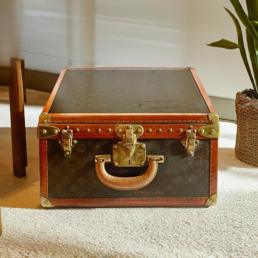This stunning Cabin trunk by Louis Vuitton from Saks & Cy - Fifth Avenue - New York store features brass corners with leather trim, two brass closures and a keyed latch. The handle is brass and the exterior proudly displays the Louis Vuitton