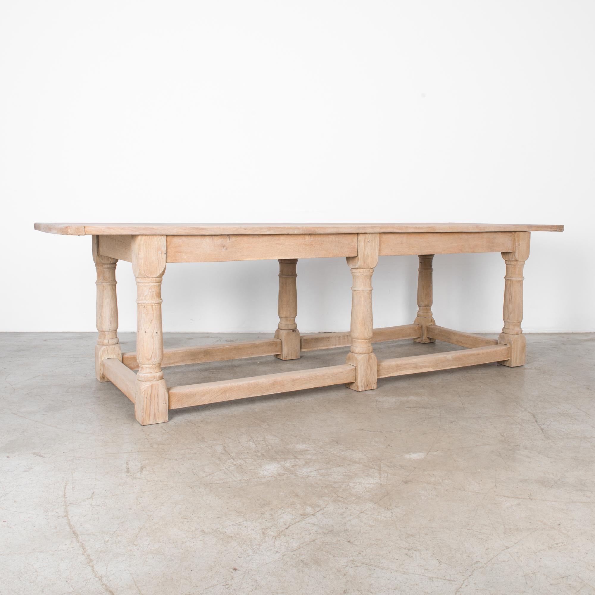 A Classic dining table from Luxembourg, circa 1940. Thick apron and legs give this oak table and extremely sturdy feel. Robust turned legs, and stretcher bars ensure this table will withstand frequent feasting. Refinished with natural oils to