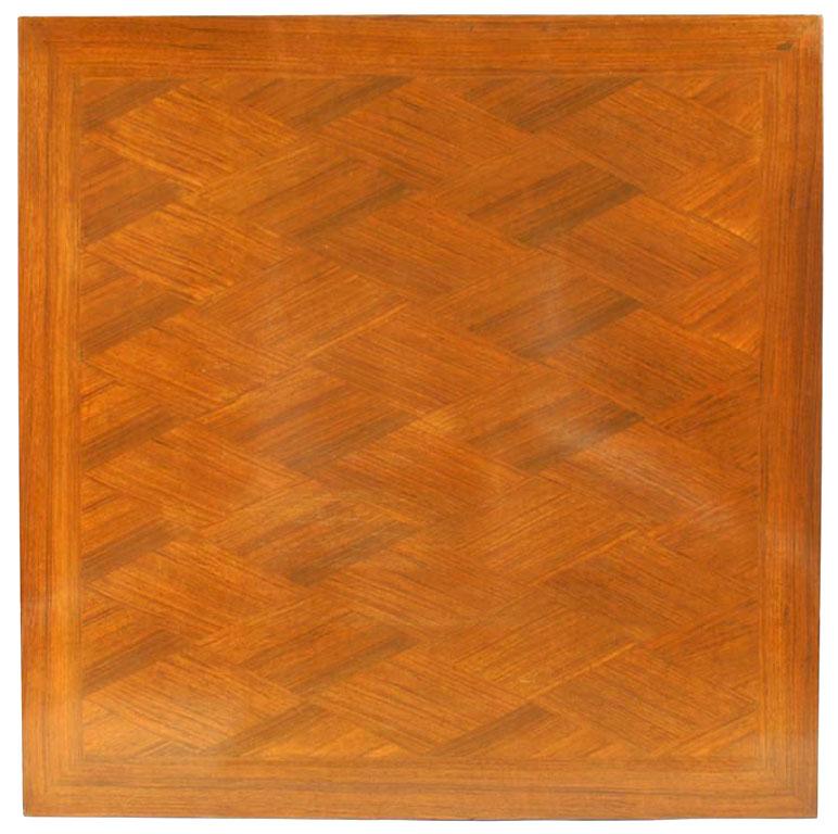 French 1940s square mahogany game table with diamond design inlaid top and scrolled capital top on square tapered legs with bronze sabot feet. (attributed to JEAN PASCAUD)
