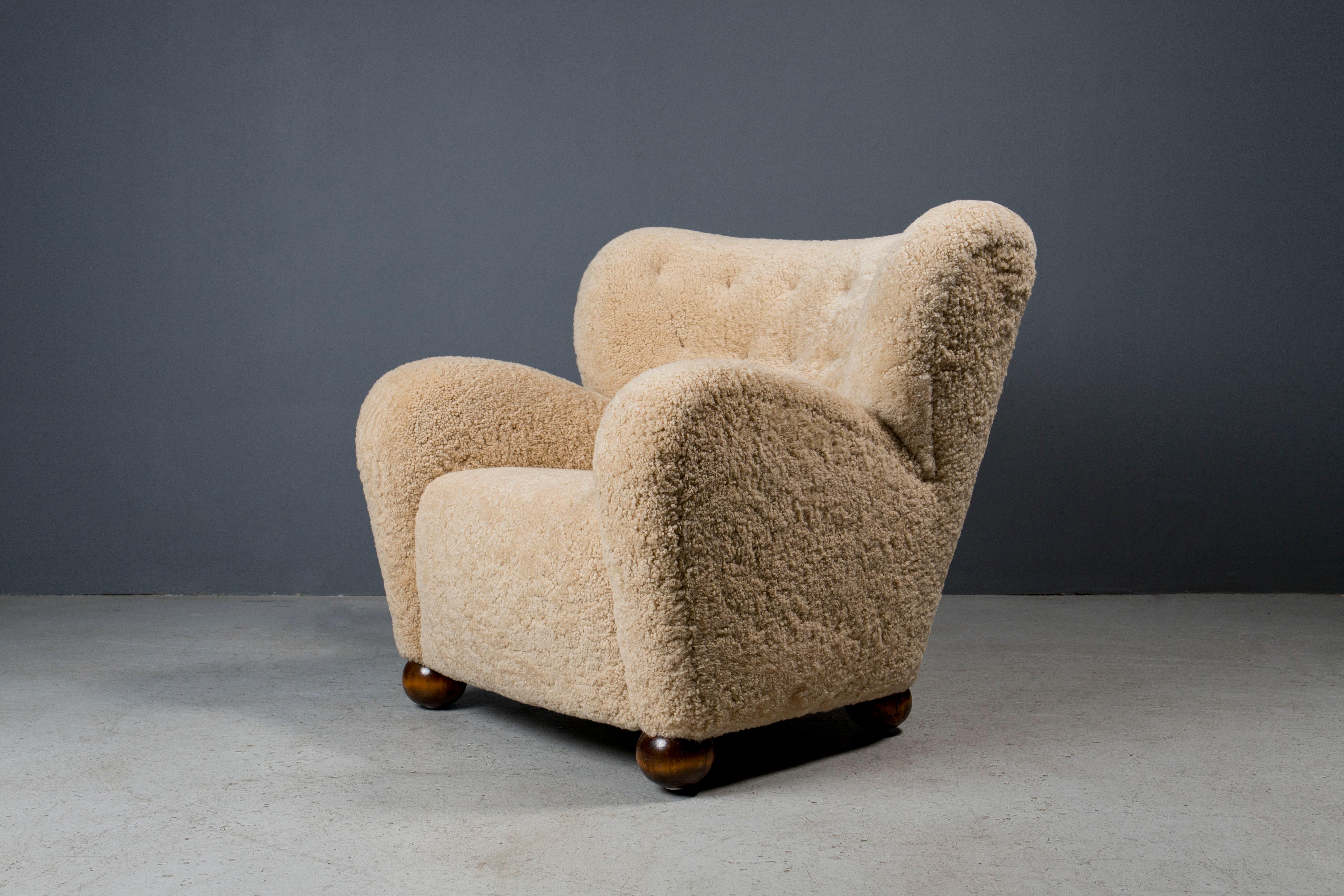 Icon 1940s Märta Blomstedt lounge chair Designed for Hotel Aulanko, newly upholstered in Australian shearling hides with brown leather buttons.

Gorgeous form, extreme comfort.