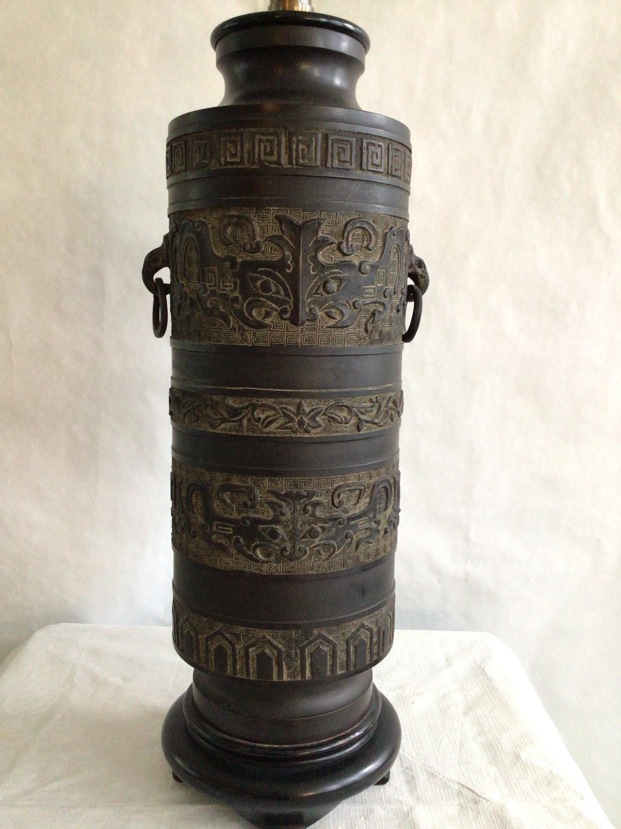 1940s Metal Table Lamp James Mont Style With Ring Handles and Greek Key Motif
Mounted on wood base
Embossed patterning throughout
Ring handles
Height to top of socket
Needs Rewiring
