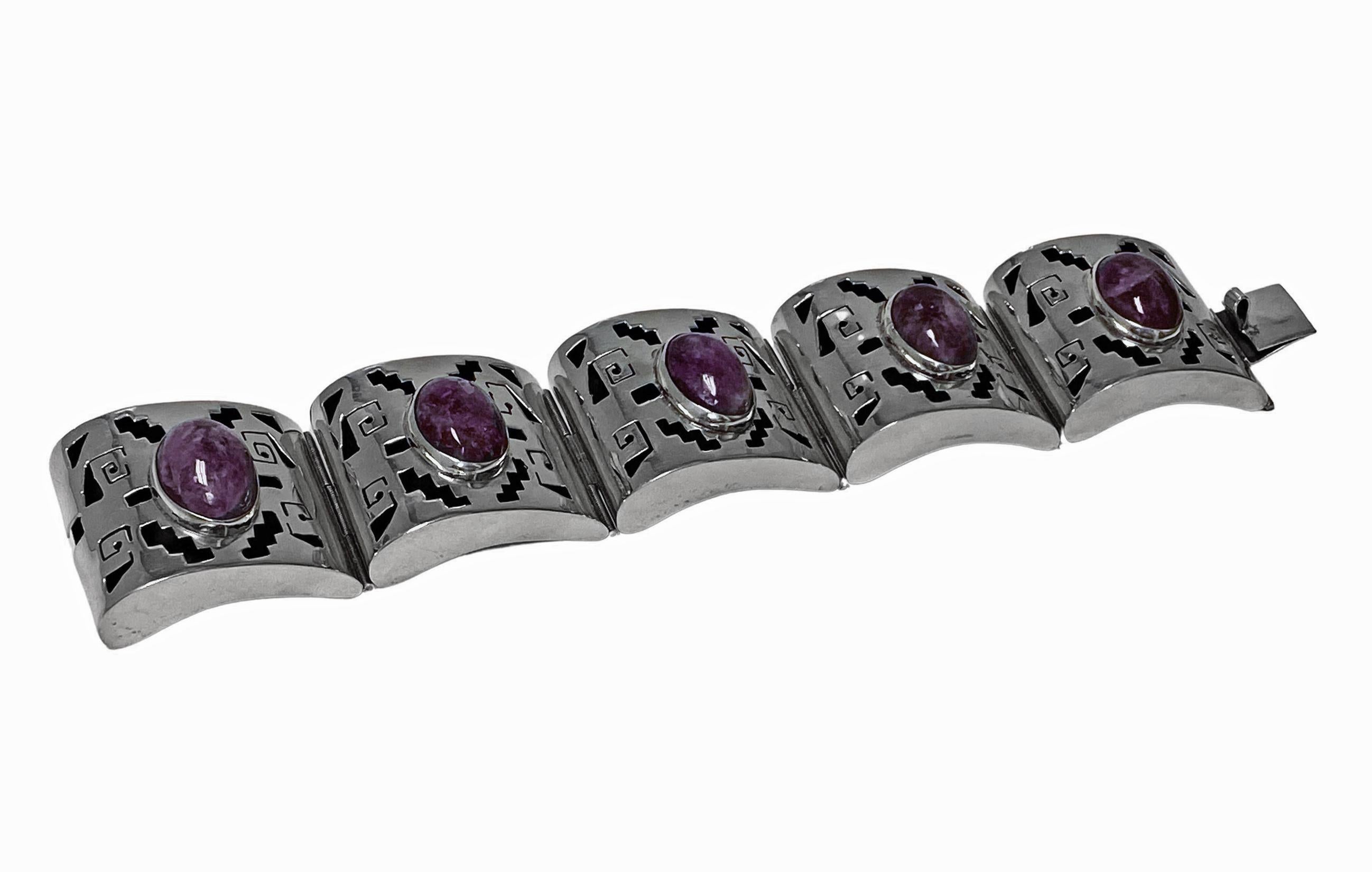 1940’s Mexican Amethyst Sterling Bracelet. The large bracelet with five section panels in curvilinear shape conforming to wrist, each with shadow cut out box design and bezel set with cabochon amethyst. Tongue and box clasp fastener. Length: 7.25