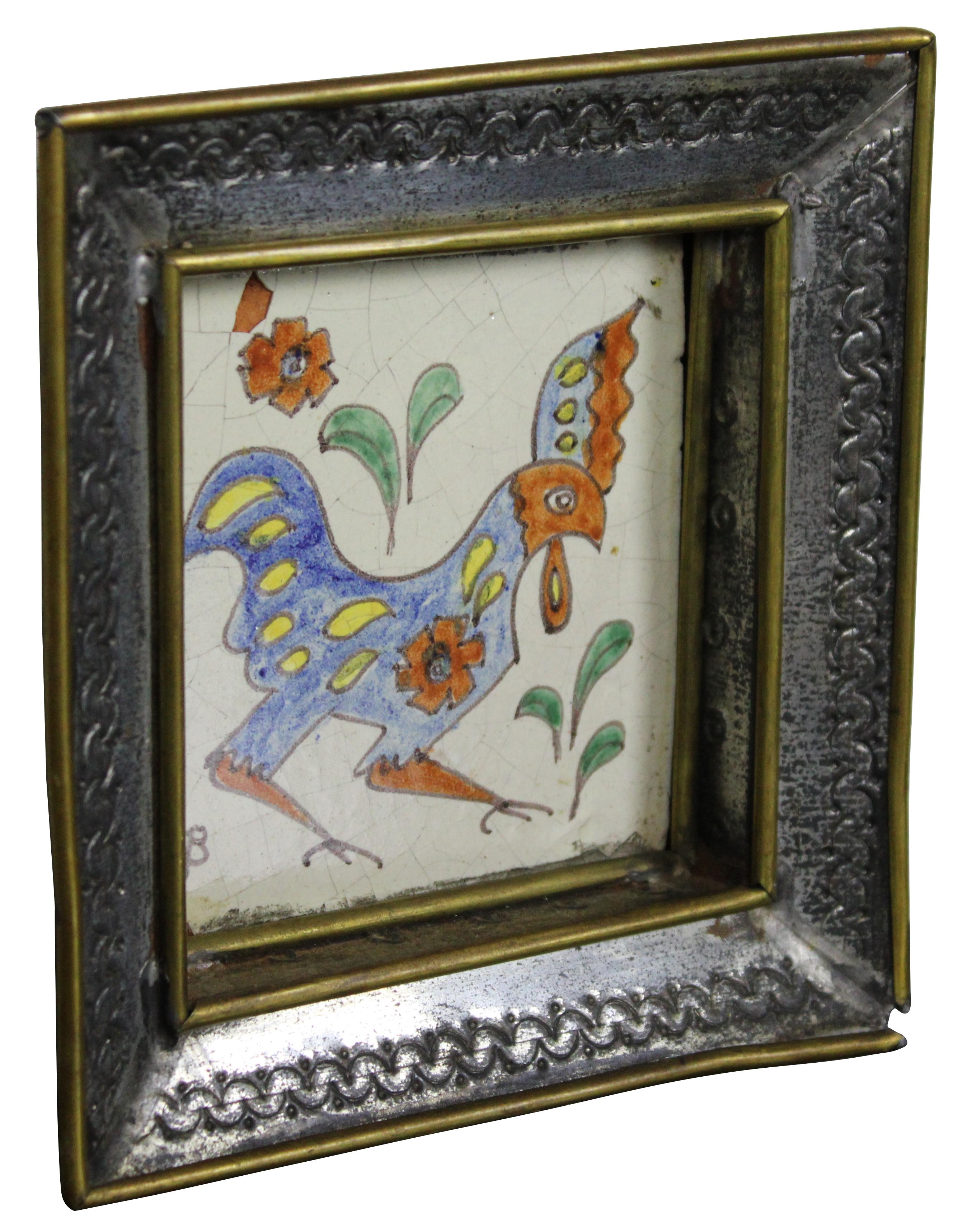 1940’s mid century ceramic hand painted rooster tile by Gene Byron, framed in a tin and brass tooled dish or tray shaped frame.

Measures: 6” x 1.5” x 6.25” / Sans Frame - 3.75” x 4” (Width x Depth x Height).
