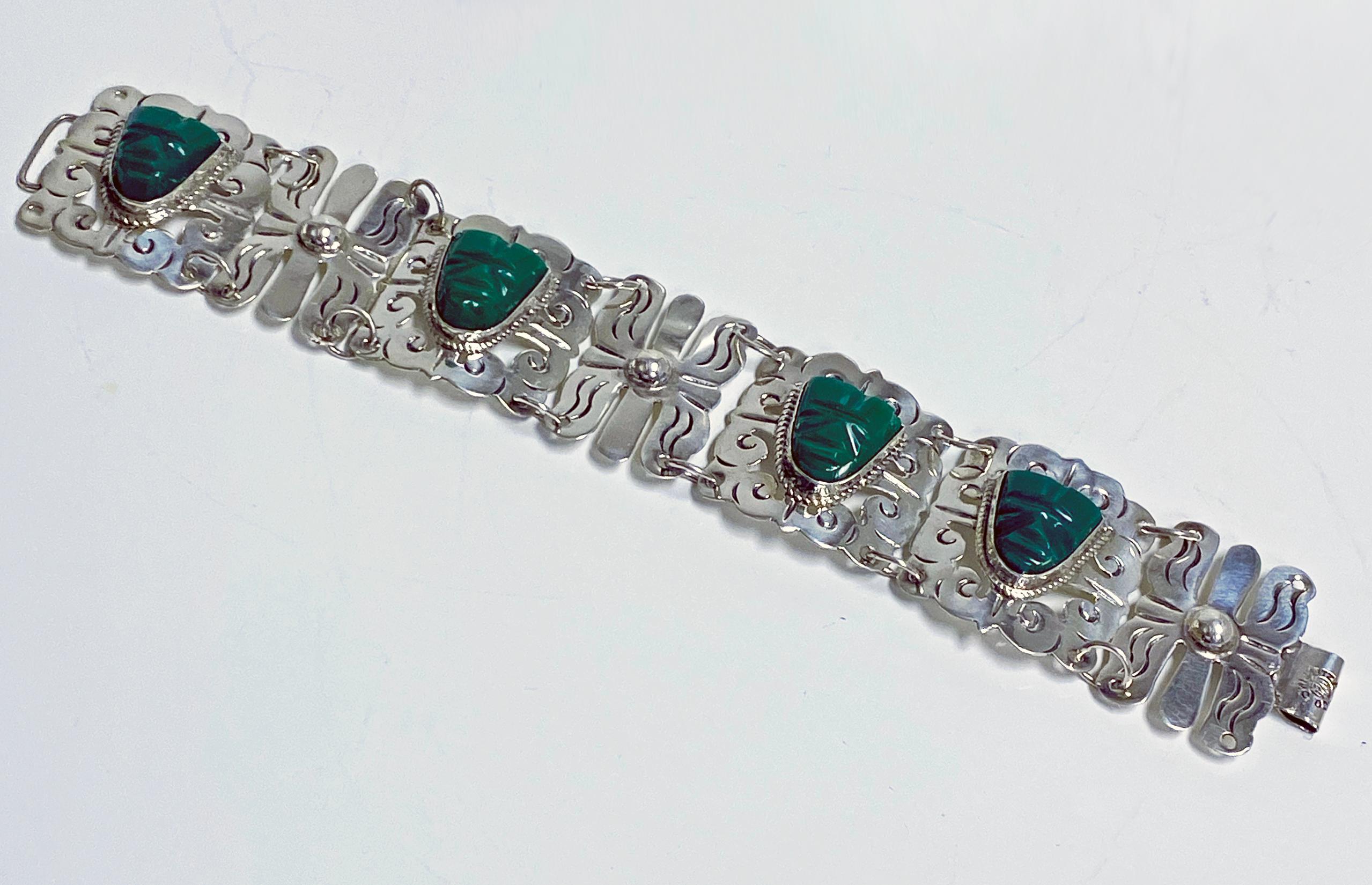 Vintage 1940's Mexican Sterling Silver Bracelet Green Onyx Tribal Aztec Masks. The bracelet with four carved green onyx face, south western style links, hook fastener conforming as clasp. Lengrth: 7 inches. Width: 1.25 inches. Item Weight: 36.19