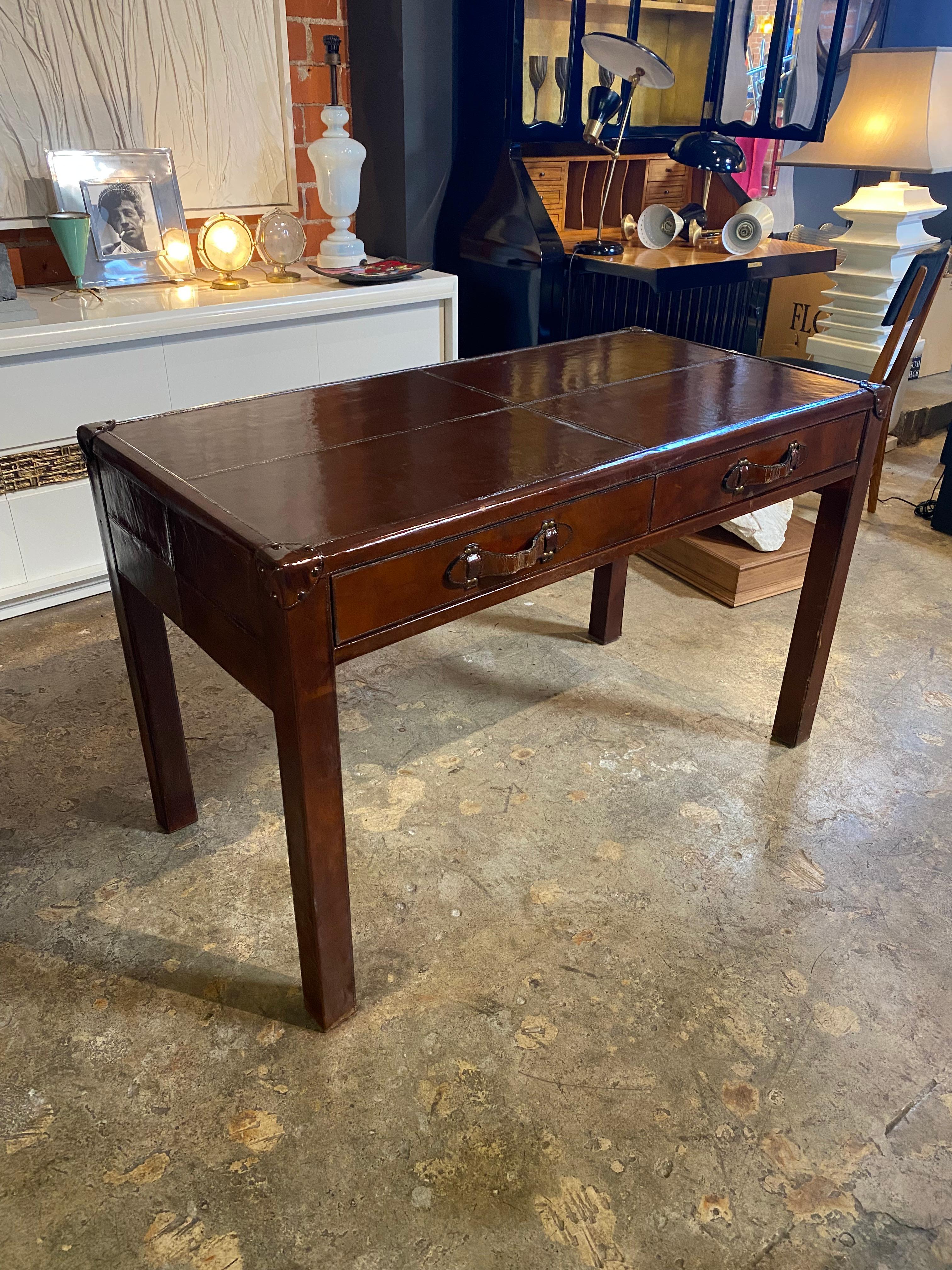 Beautiful Italian Mid century modern leather desk with two drawers. The desk had ben polished in the best possible way to get it back as good as new.• An elegant and simple item that will complete a midcentury study.
