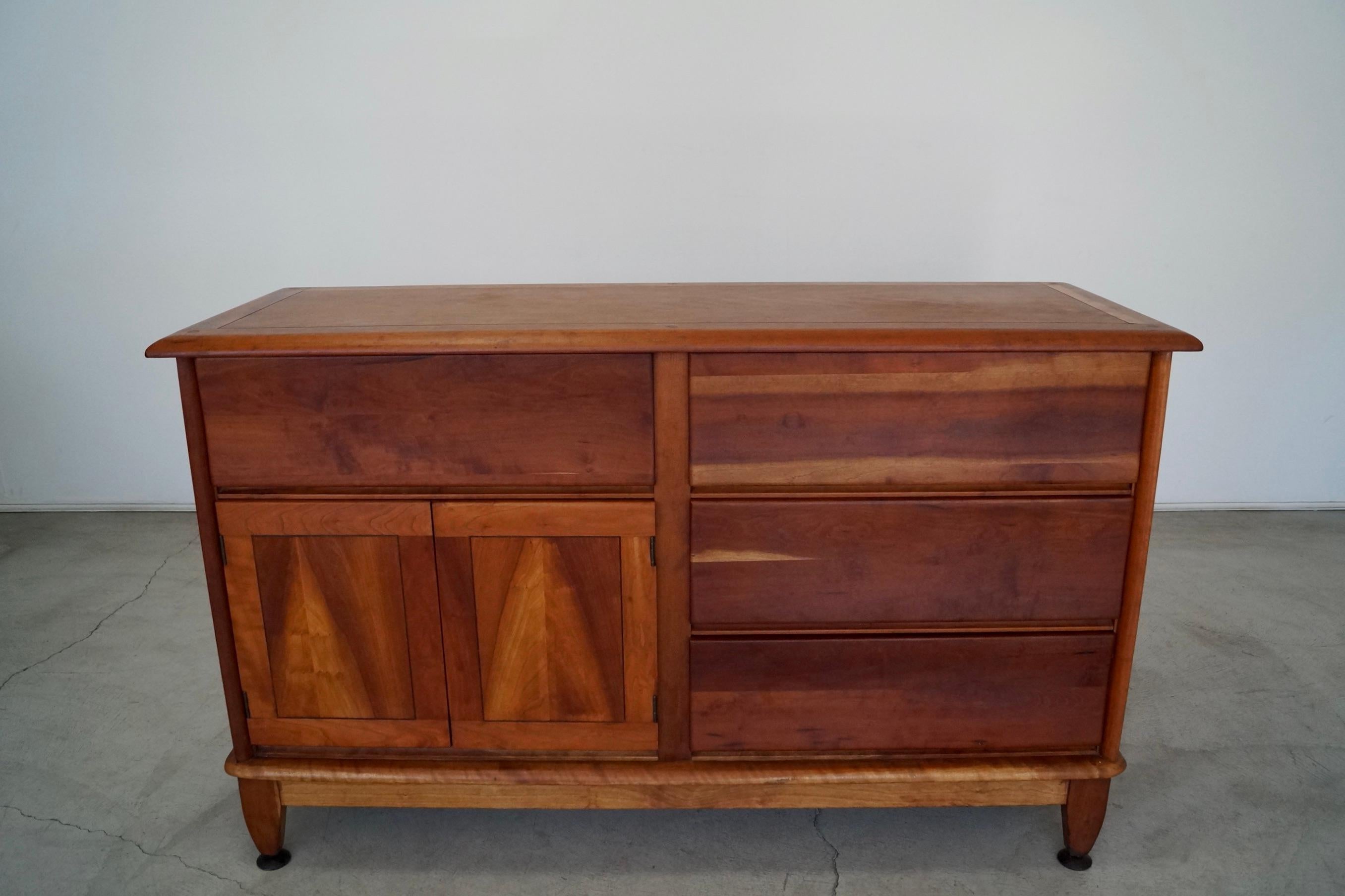 Incredible vintage Mid-century Modern credenza for sale. From the late 1940's, and manufactured by Morris of California. It still has the Morris stamp, and is made of solid cherry wood. There are absolutely no veneers or particle wood in the