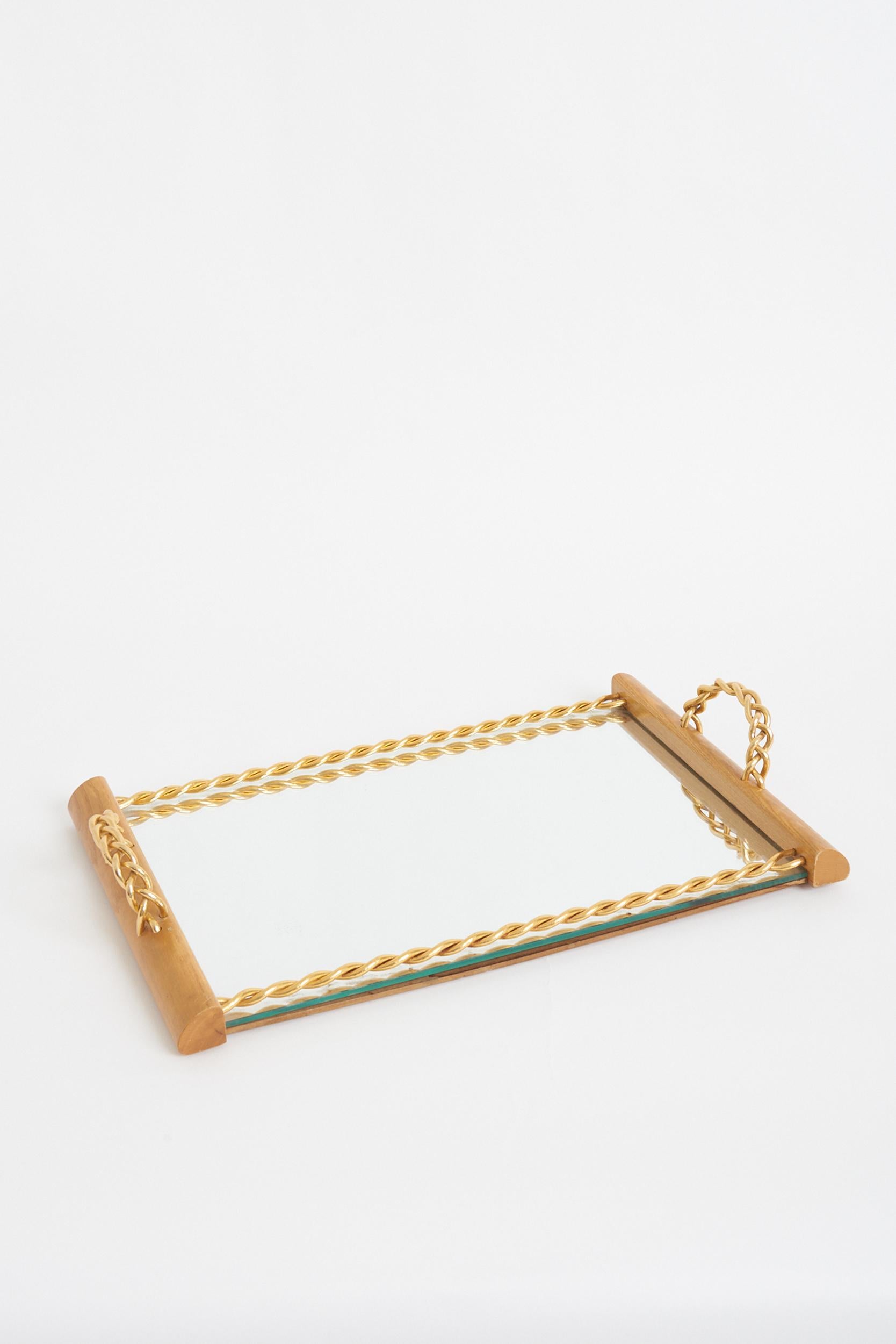 An oak mirrored tray, with gilt chain handles and frame.
France, circa 1940-1950.