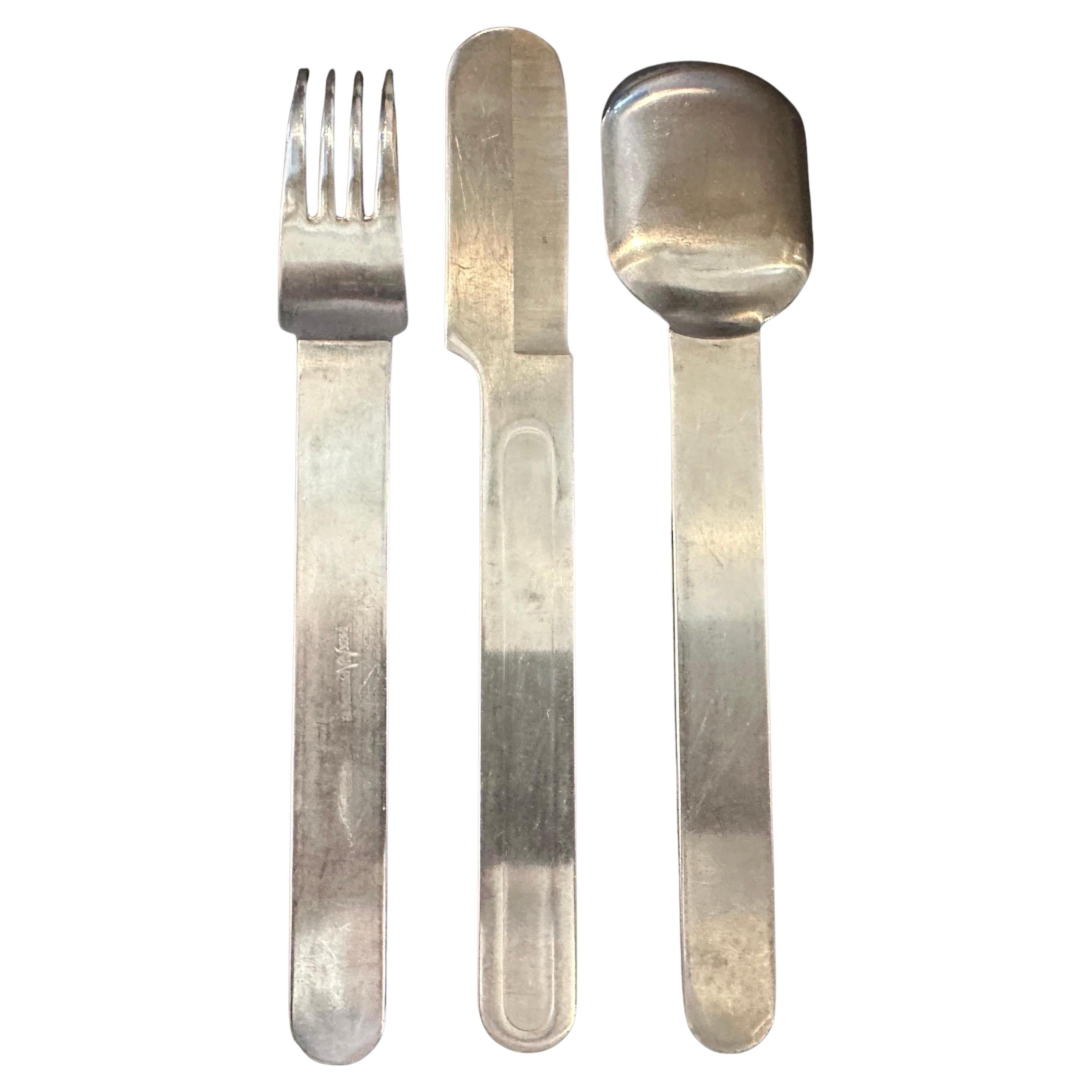 This stunning vintage three-piece cutlery set from the 1940s, with its clean lines and minimalist design embodies the timeless elegance of the Modernist movement. Crafted from Alpaca, a durable and silver-like alloy, this cutlery has a beautiful