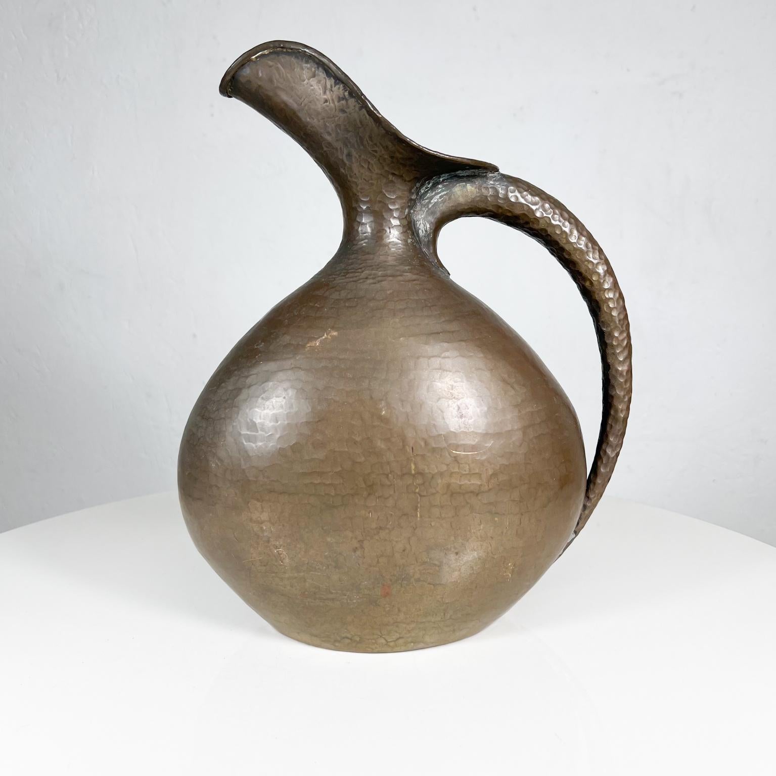 1940s Modernist hammered brass pitcher by Italian designer master craftsman, Egidio Casagrande, Italy. 
Measures: 12 tall x 9.5 W x 4.63 D.
Maker stamped Italia numbered, Egidio Casagrande.
Preowned original vintage condition.
See images