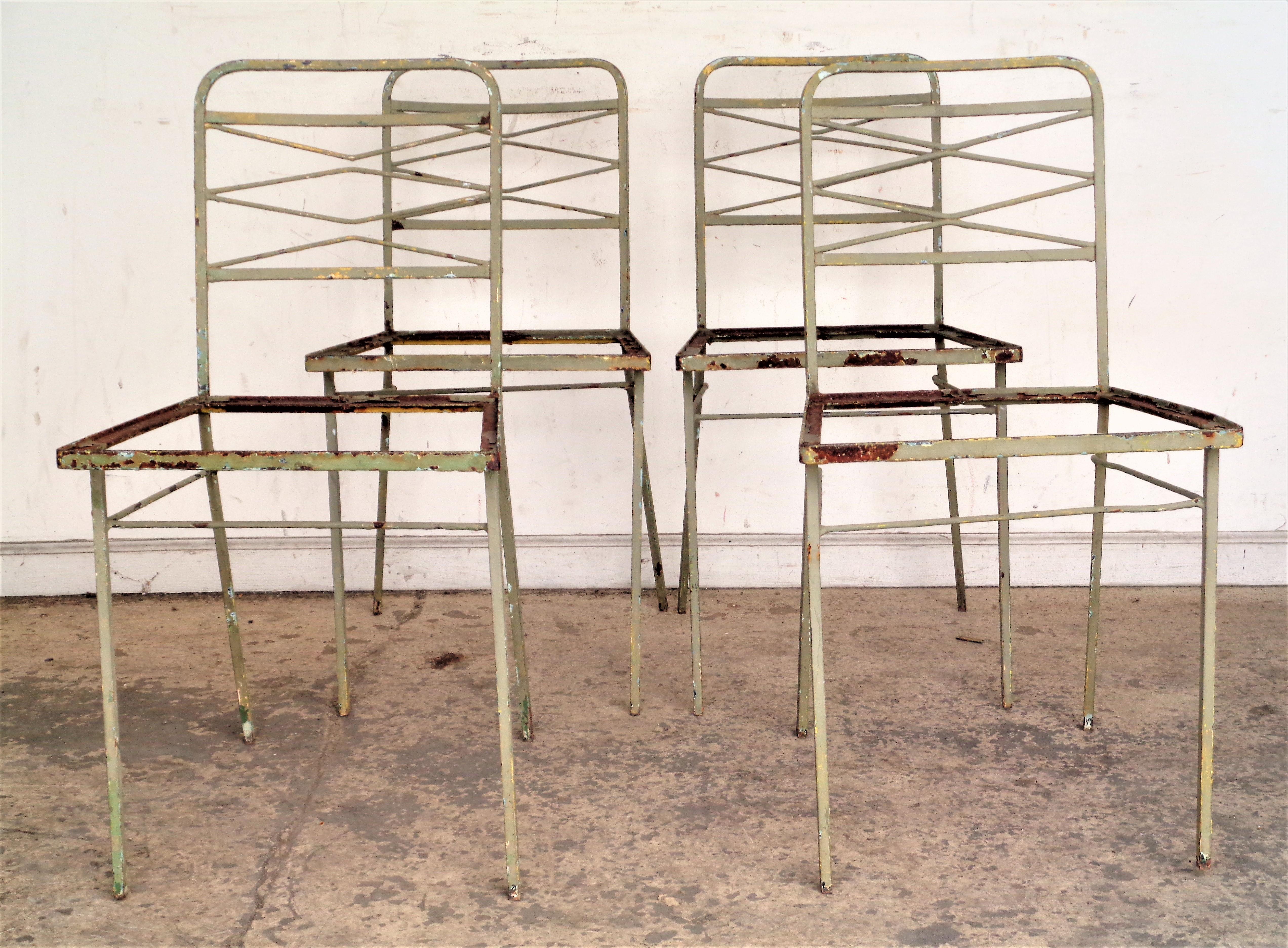 A set of four modernist wrought iron chairs in beautifully aged old worn pale sage green painted surface. Great looking. Circa 1940's. For interior or garden. Look at all pictures and read condition report in comment section.