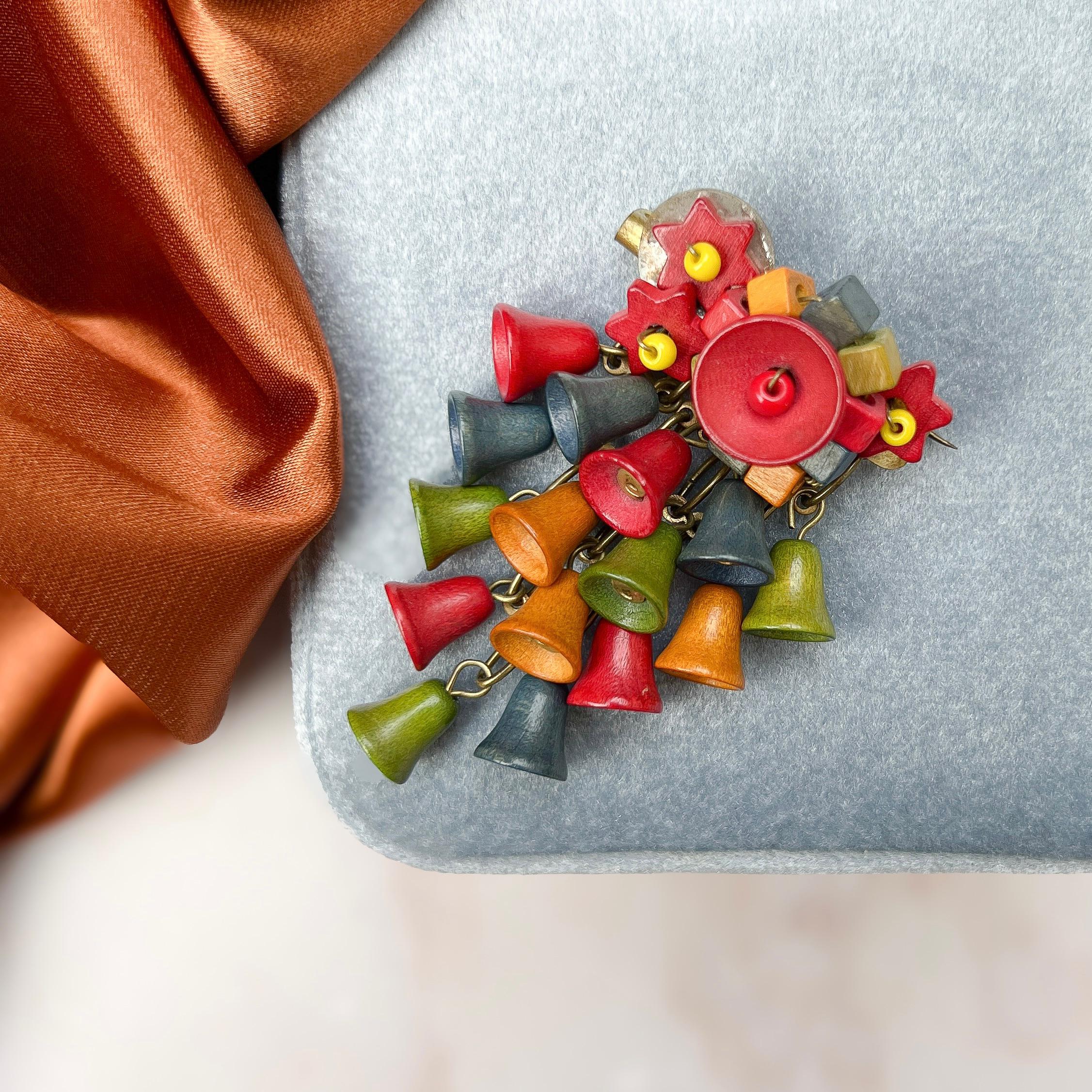 This lovely brooch reflects the vogue for wooden jewellery during the 1940s. It resembles early pieces created by the American Miriam Haskell company and some Czechoslovakian jewellery designs. 

Condition Report:
Excellent 

The Details...
This