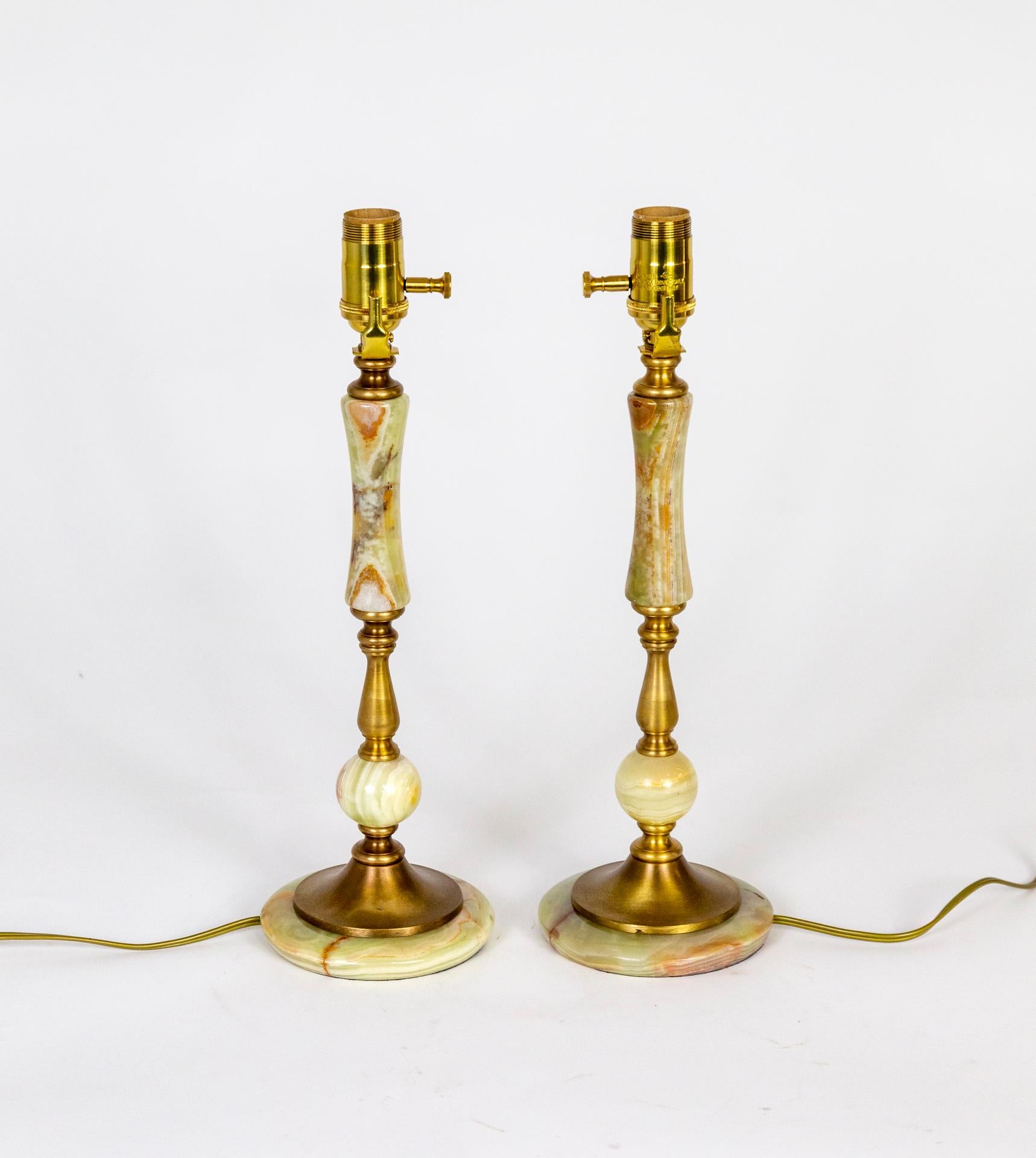 A pair of 1940s, variegated light green onyx lamps with shades of cream and rust tones, and brass pieces integrated in the form. Newly wired with dimming sockets. 5