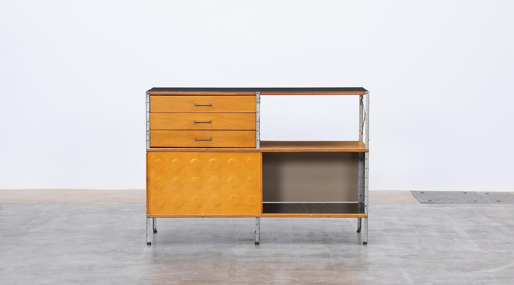 Plywood, laminate, metal, ESU shelf by Ray & Charles Eames, USA, 1949.

ESU shelf, multicolored by Charles and Ray Eames featuring an open area and three drawers in the upper section and two sliding doors in the lower section. The basic colour