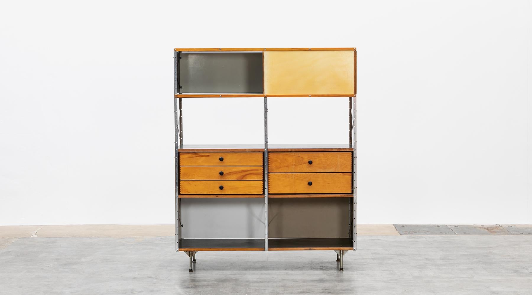 Charles and Ray Eames storage unit featuring five drawers in the middle area. Side and back panels feature a color combination of grey, beige and black. The shelf comes in good original condition with patina. Manufactured by Herman Miller.

Ray