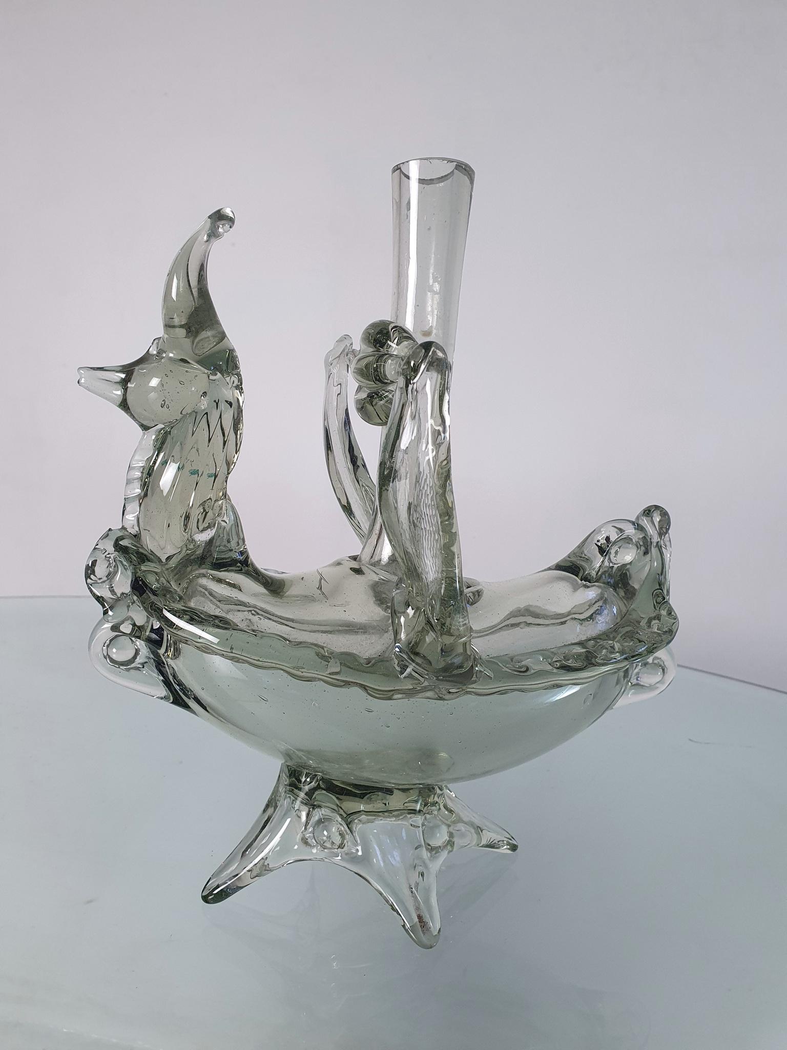 A unique Murano glass vessel that can be used as a vase, bottle or a candle holder in the shape of some kind of mystical fox in the front and a boat shape at the same time. Produced in Murano during the 1940s.