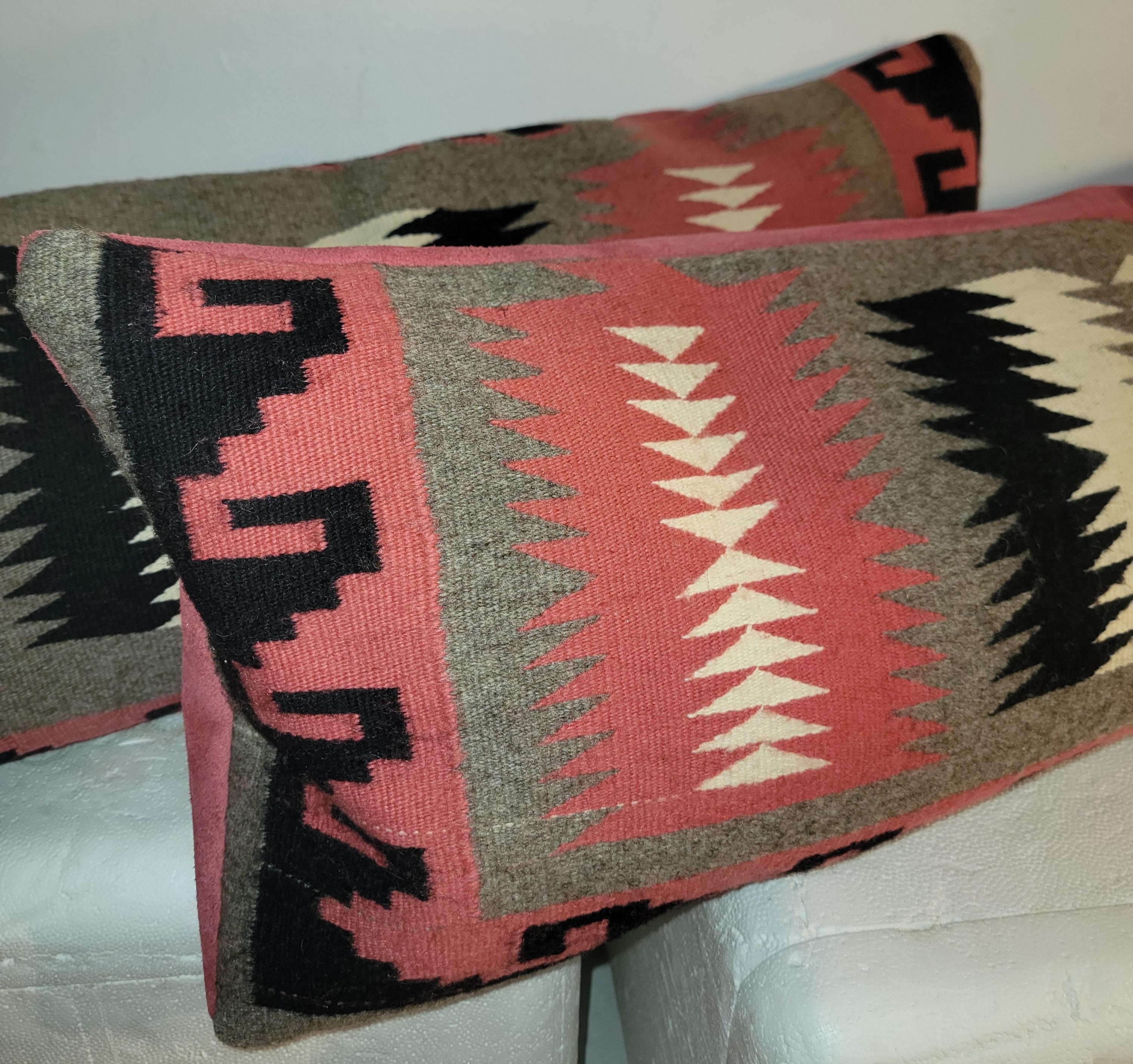 These fine tightly woven pastel Navajo in very good condition. Interesting Eye dazzler pattern and the backing is in a Mauve suede leather. Inserts are custom made down and feather filled. 