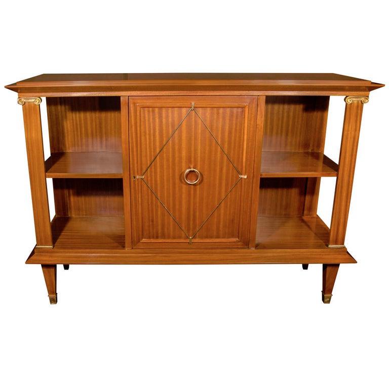 French Art Deco sideboard and bookcase made of exotic ribbon striped Cuban mahogany wood. Neoclassical design features architectural elements with Directoire style accents. The sideboard has display shelves on either side and a center door fitted