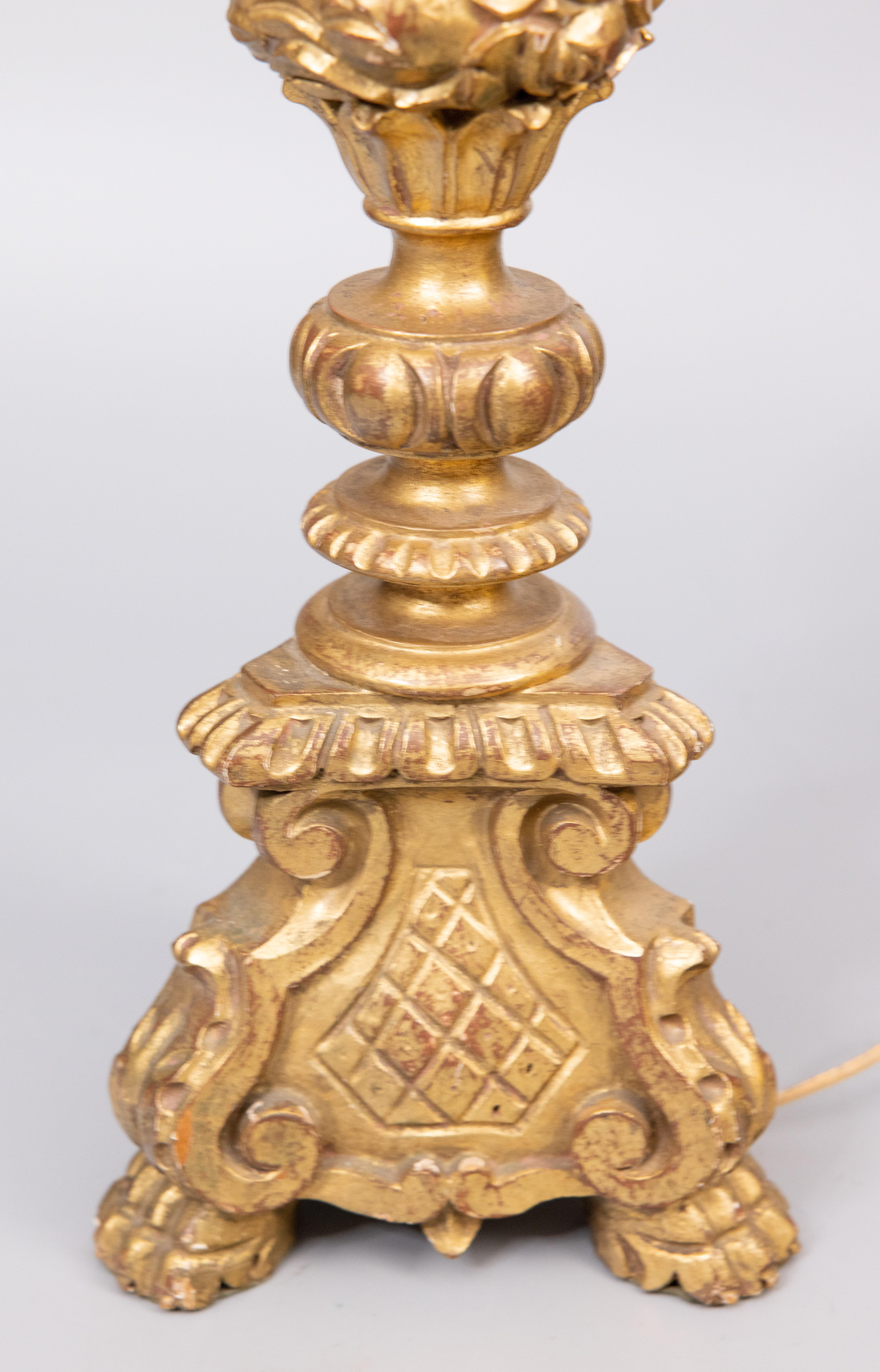 A gorgeous Italian hand carved gilt wood and gesso tripod pricket candlestick lamp, circa 1940. Marked 