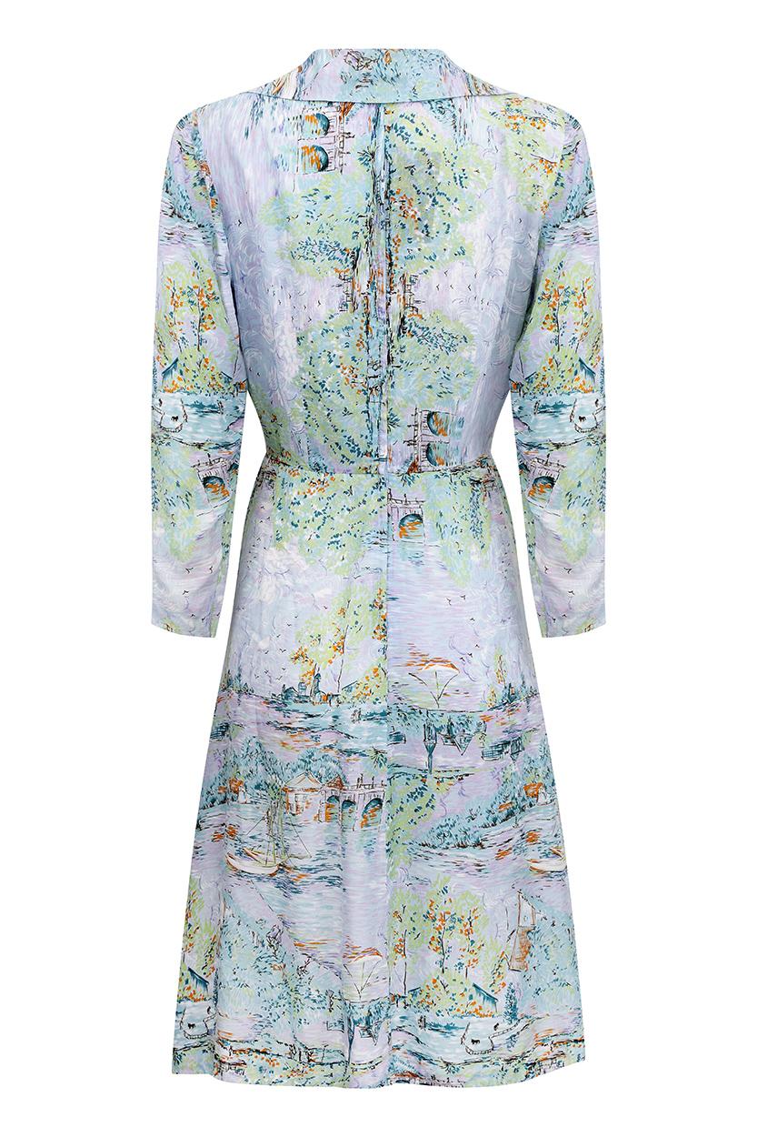 This charming 1940s pastel toned shirt dress is in beautiful vintage condition and has a feminine, contemporary aesthetic. The light rayon fabric has an impressionist style novelty print depicting riverside scenes with sailing boats and pasture land