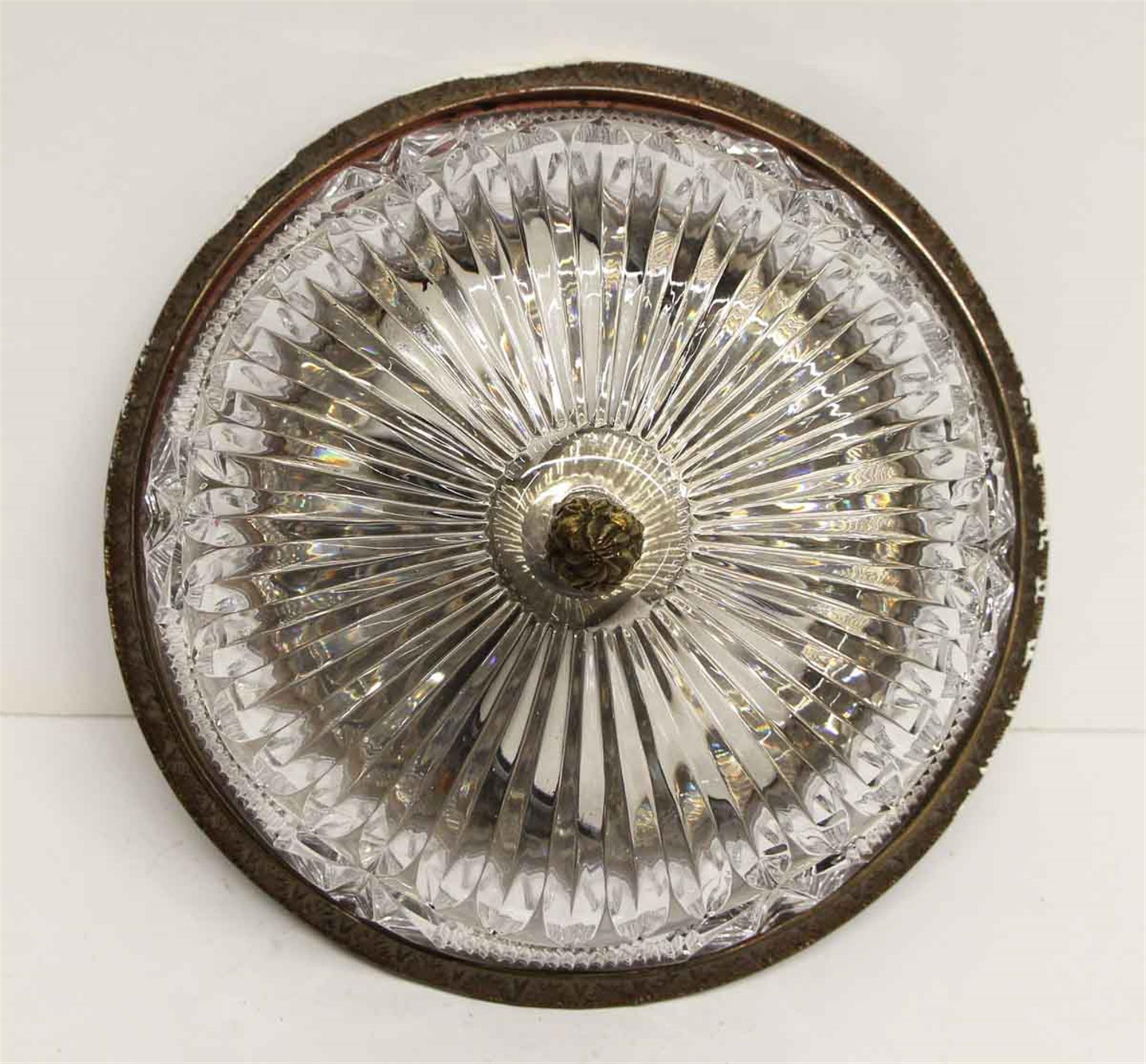 1940s heavy cut crystal flush mount fixture with a cast brass or bronze ornate rim and finial. From the NYC Waldorf Astoria Hotel. Price includes wiring and cleaning. A Waldorf Astoria authenticity card included with your purchase. This can be seen