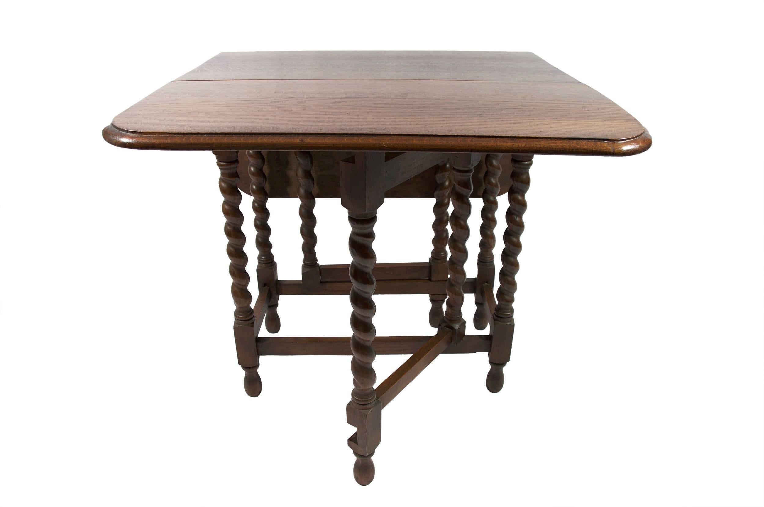 1940s English-made, medium oak color, drop-leaf and gate-leg table.