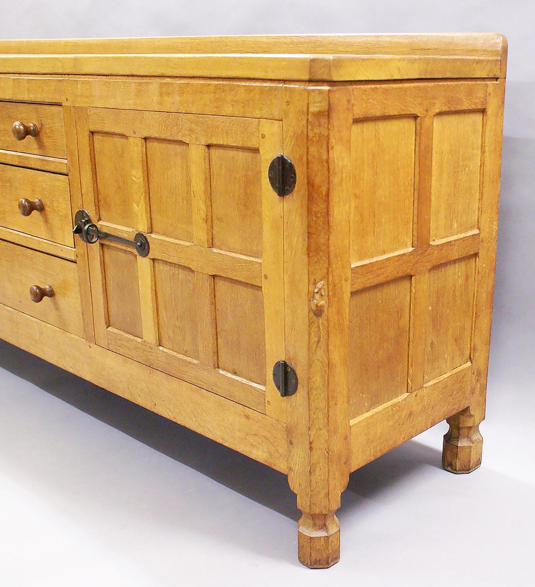 This beautiful and well-proportioned sideboard was made by Robert Thompson, a prolific and well-known furniture maker of the period. A small carved mouse was his signature and trademark, which eventually became his nickname.
Robert Thompson, born