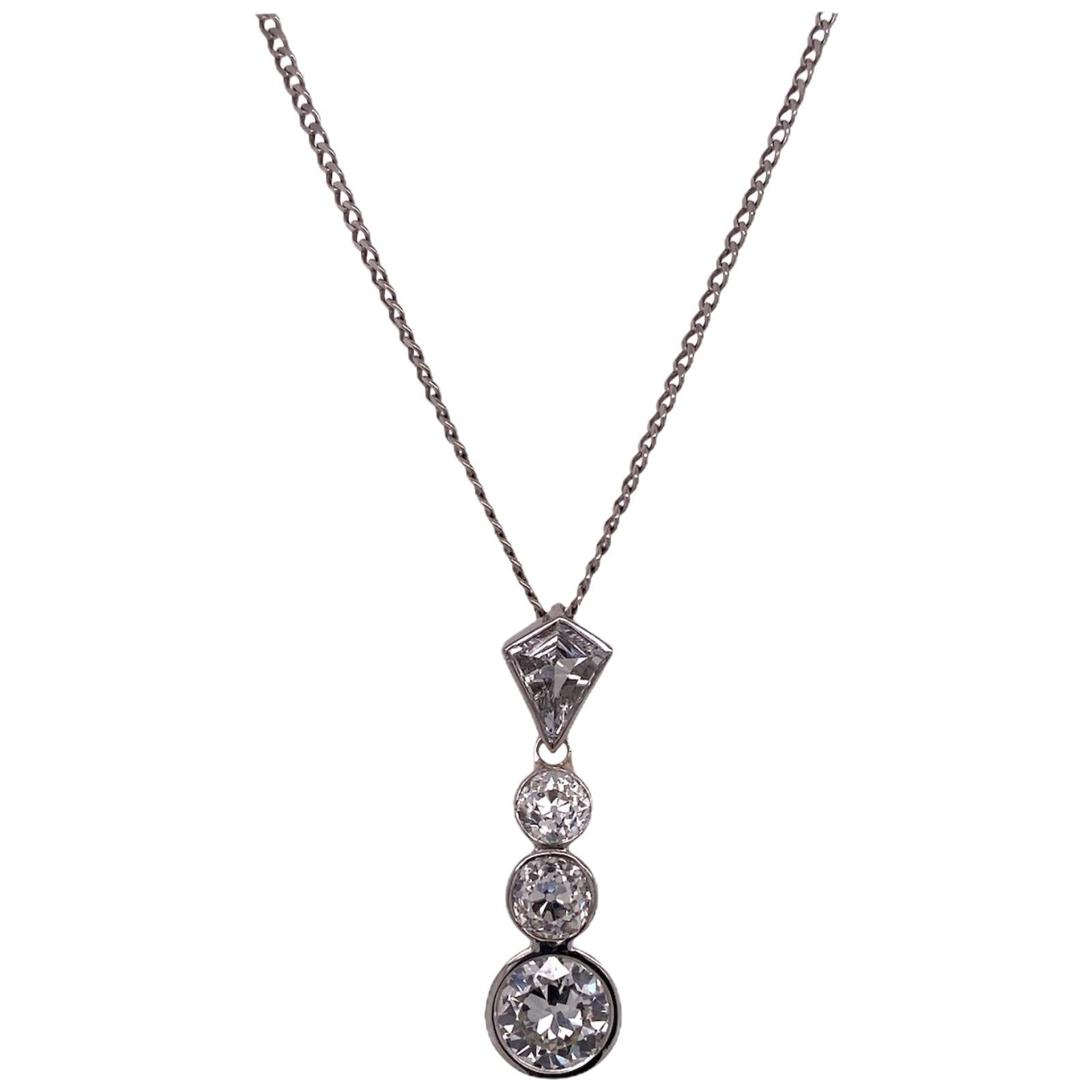 Diamond drop estate necklace fashioned in platinum. The necklace features an Old European cut diamond weighing 1.00 carat,  two additional Old Europeans weighing .62 carat total weight, and a single kite shape diamond weighing .43 carats. The