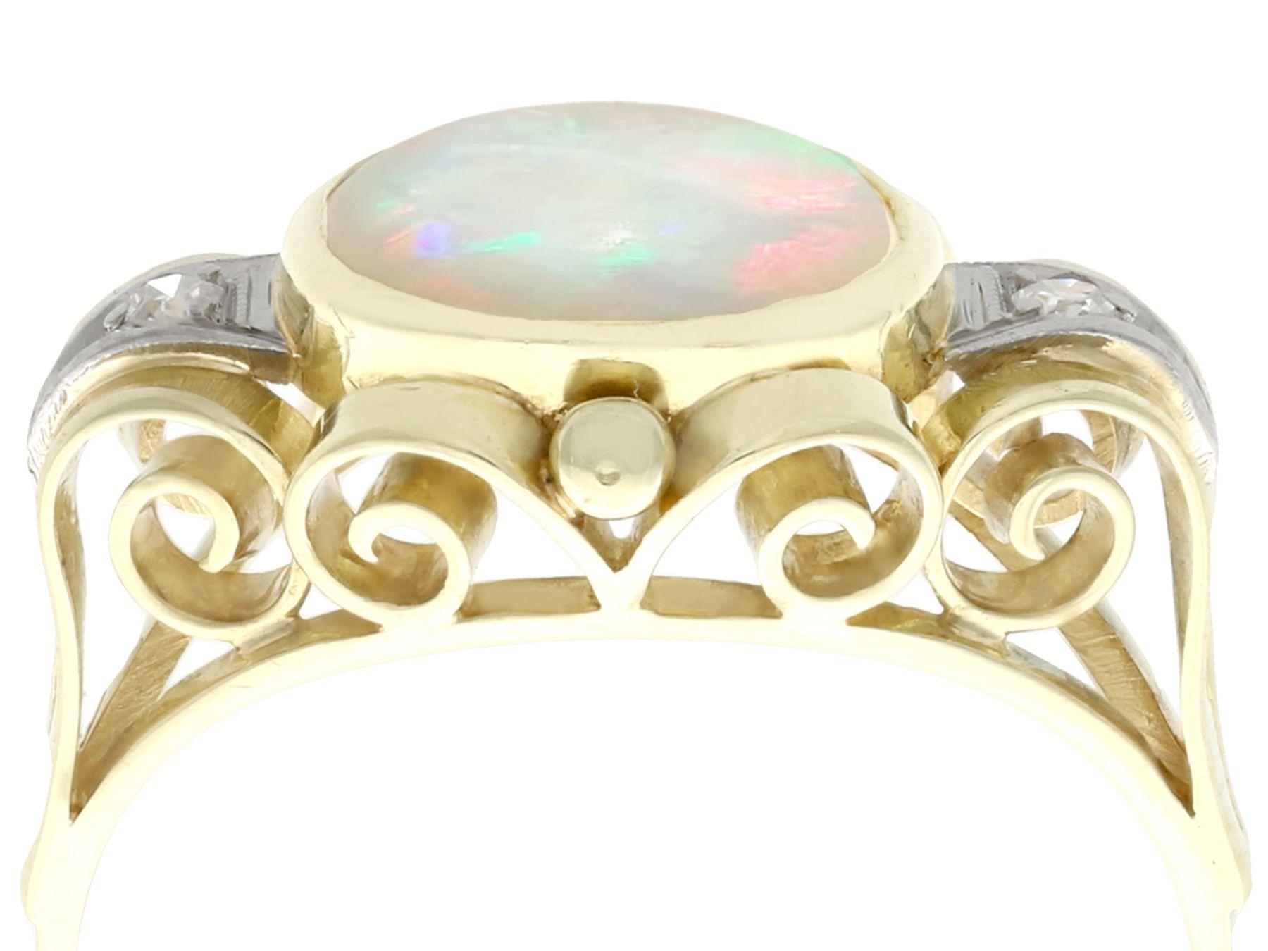 An impressive vintage 1.10 carat opal and 0.04 carat diamond, 14 karat yellow gold and 14 karat white gold set cocktail ring; part of our diverse gemstone jewelry collections

This fine and impressive cabochon cut opal and diamond cocktail ring has