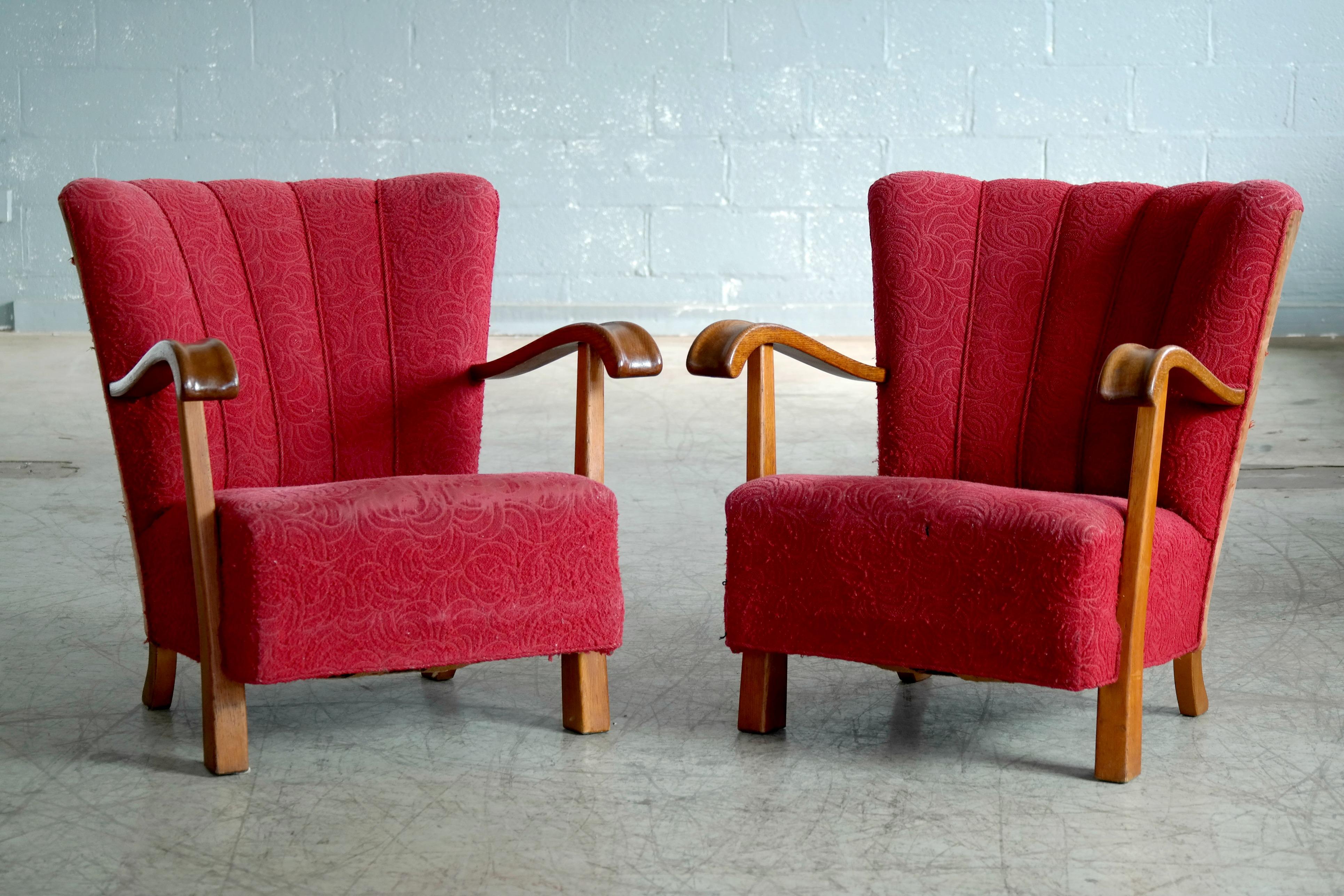 Very cool Danish early midcentury pair of open armrest lounge or club chairs made from oak wood in the 1940's. While it is not known who is the maker and designer behind these chairs we see this model from time to time in the Danish market