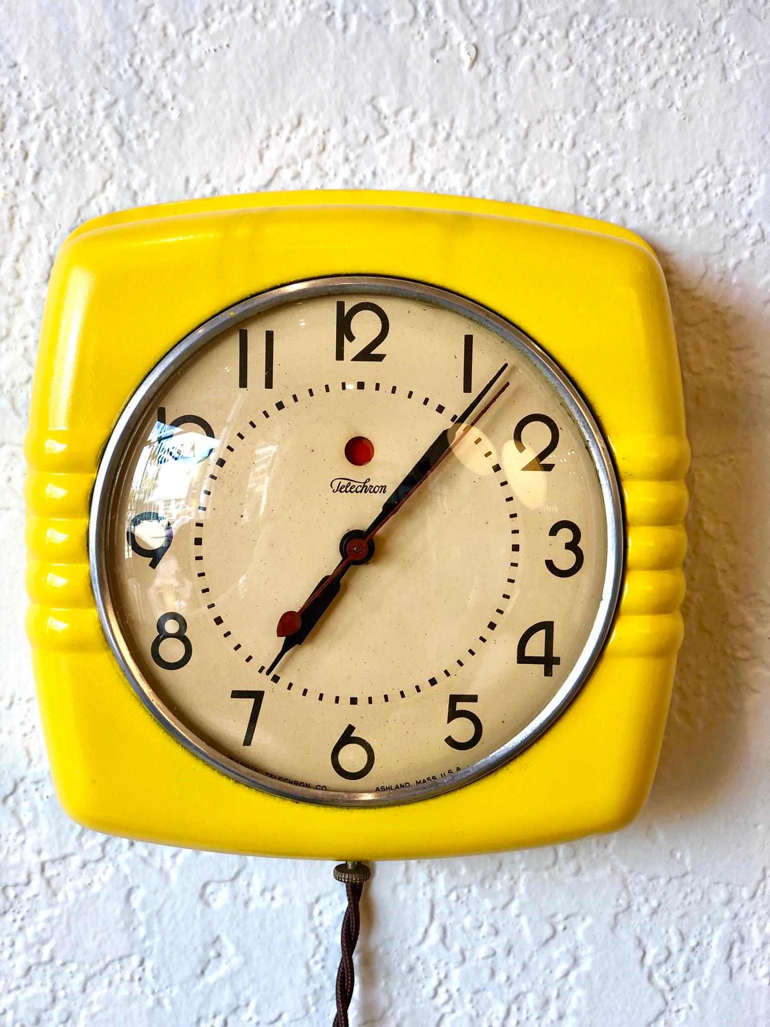 Beautiful yellow metal and glass Art Deco wall clock completely restored to its glory days, new cloth extended cord the piece has been resprayed in yellow, and its in perfect working condition. Glass case and metal frame.