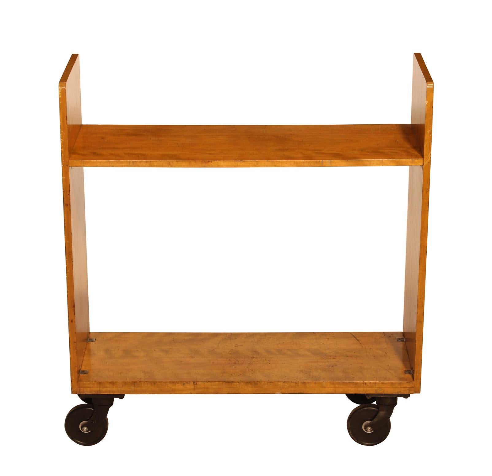 Authentic 1940s library cart made by 'Remington Rand Library Bureau Div - Made in USA' - Four cast iron casters read - 'Kilian Manufacturing Corp. Syracuse N.Y.' - Structurally sound and in well worn condition. Overall dimensions: Width 39 1/8